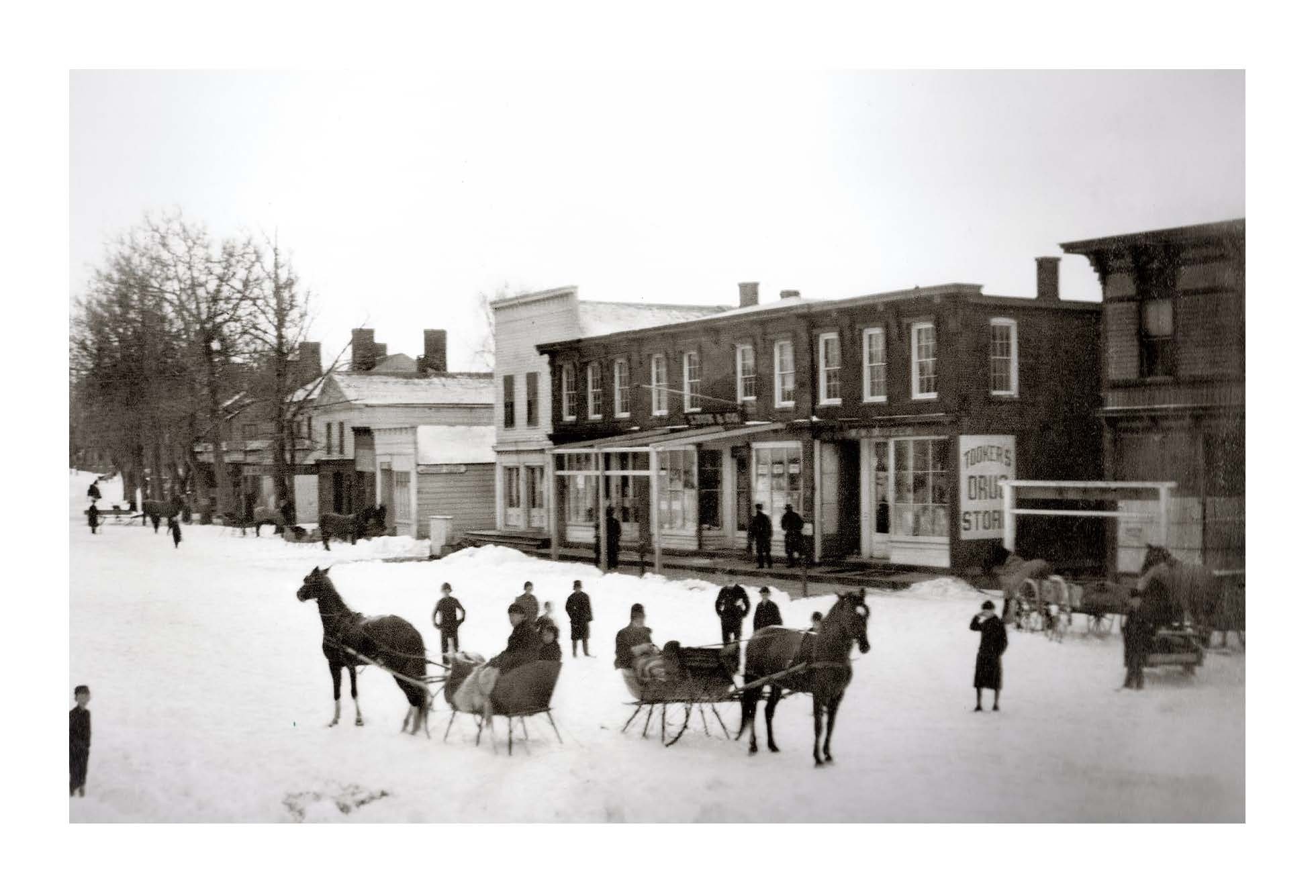 William Wallace Tooker's photo of Main Street, Sag Harbor in the snow, c. 1882. The Tooker Drugstore can be seen in the image.