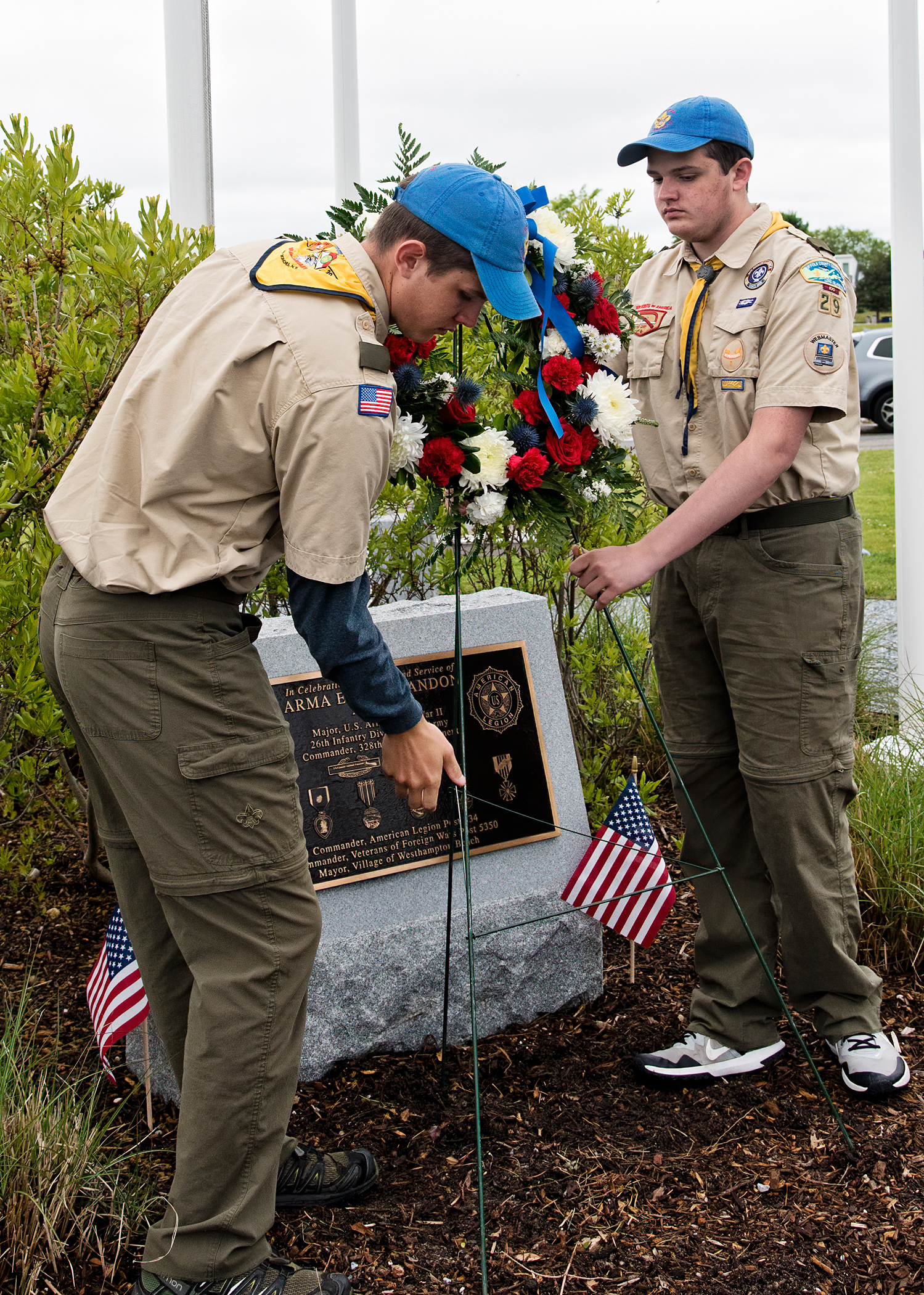 Scouts from Troop 29 in East Moriches lay a wreathe at the plaque honoring World War II veteran and Westhampton Beach mayor Arma “Ham” Andon at the village marina.  COPURTESY WESTHAMPTON BEACH FIRE DEPARTMENT