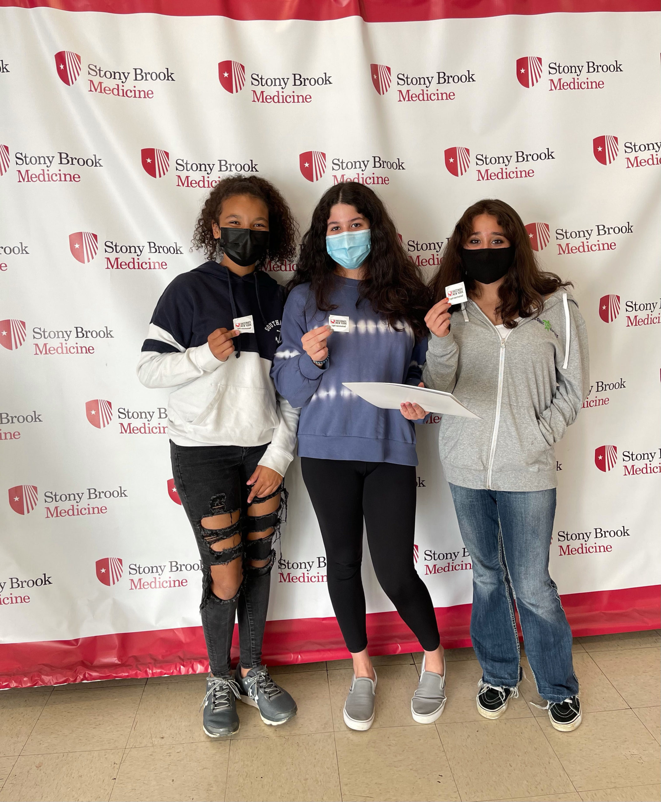 From left, Mya Halsey, 13, Stella Lima, 15, and Ava Lima,14, all received their first dose of the Pfizer COVID vaccine at Stony Brook Southampton College on May 13.