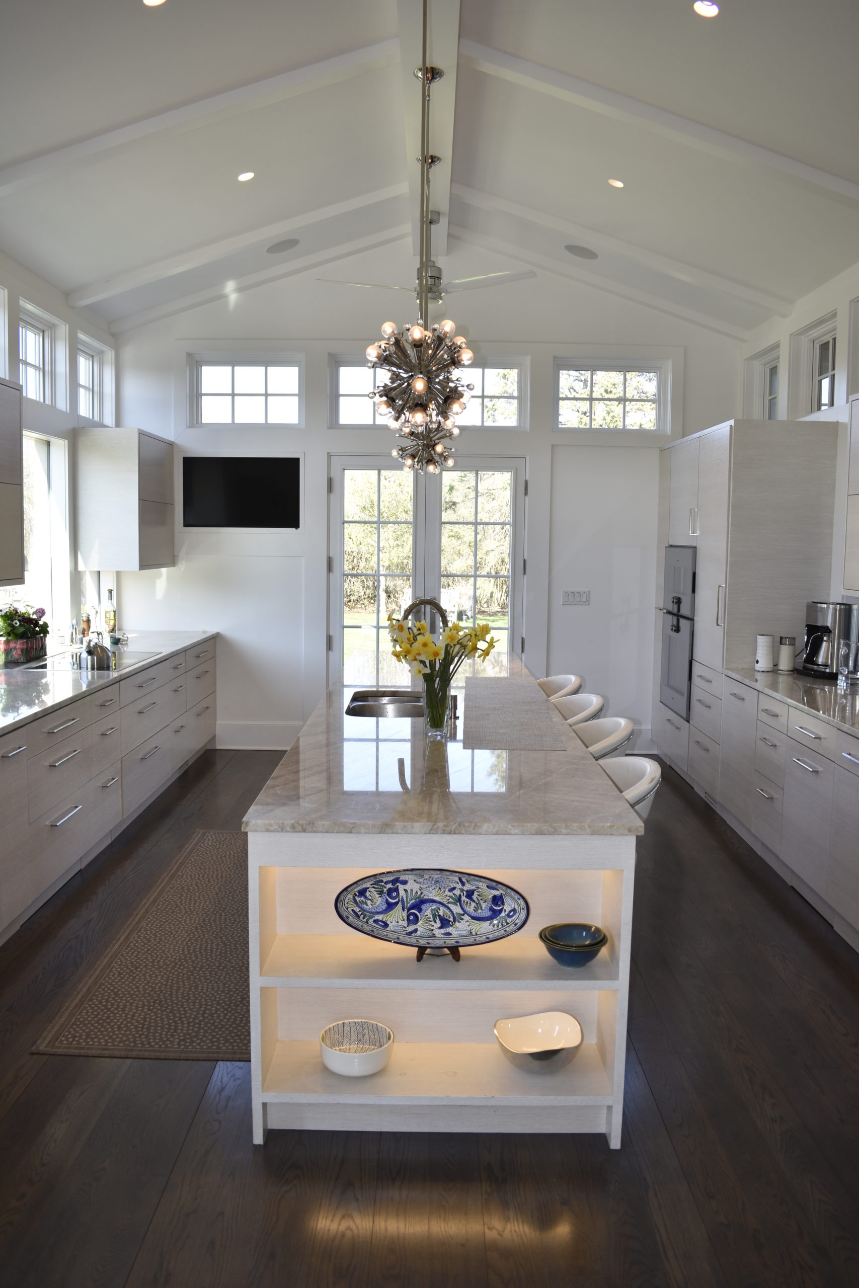 The kitchen in Evan Mason's Sagaponack home, with LED lighting, a wall of glass to the left, and energy and water efficient appliances.