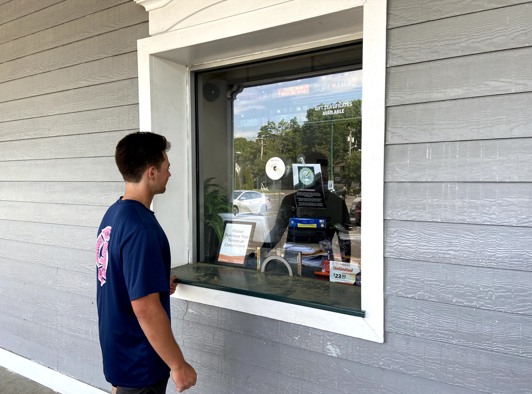 Jordan Adelson, 18, stands in front of movie poster Scoob, which now being shown at the Hampton Bays movie theater.