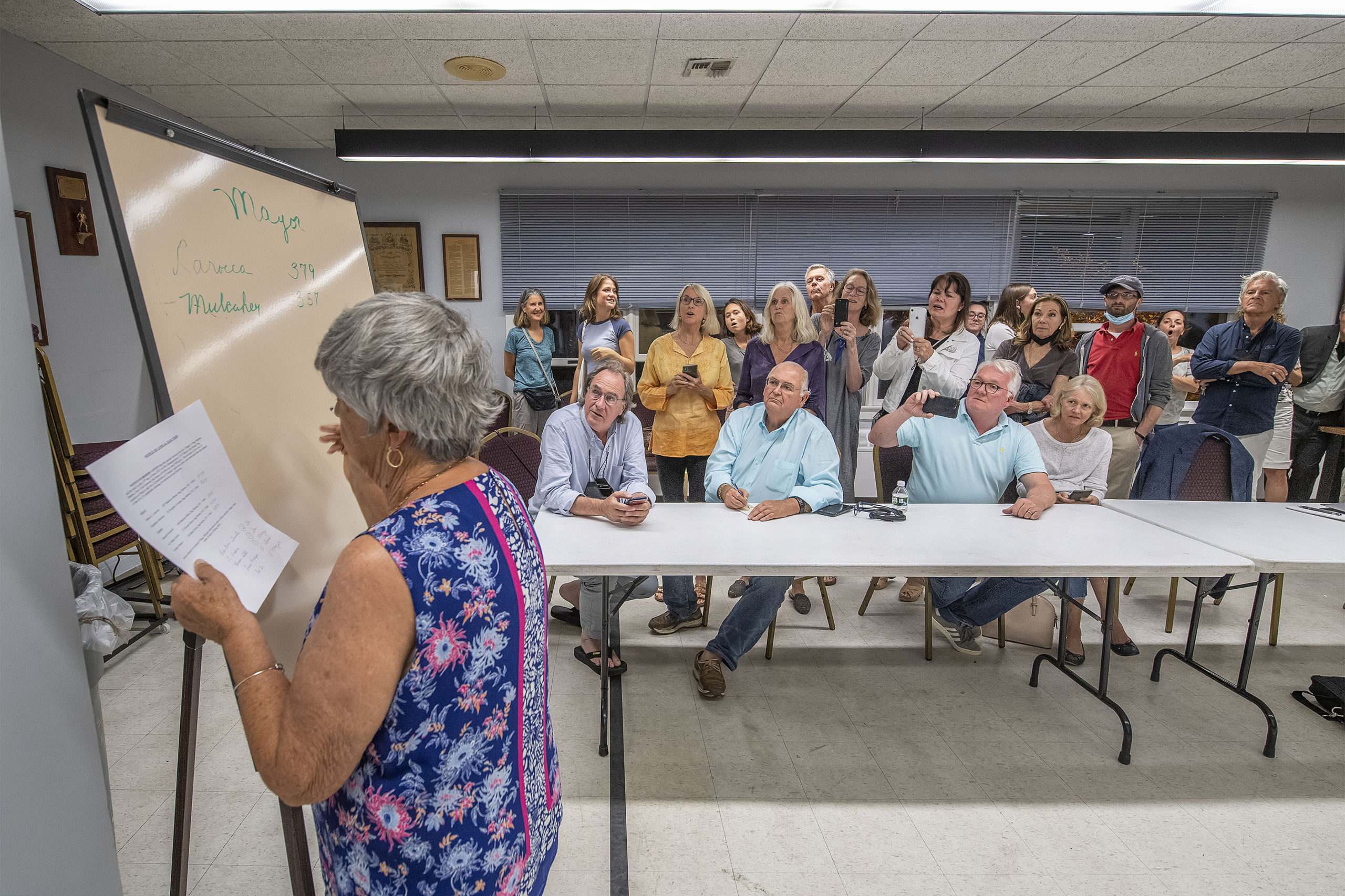 Diane Schiavoni had the rapt attention of onlookers as she wrote down the results of Sag Harbor's hotly contested mayoral race Tuesday night. MICHAEL HELLER
