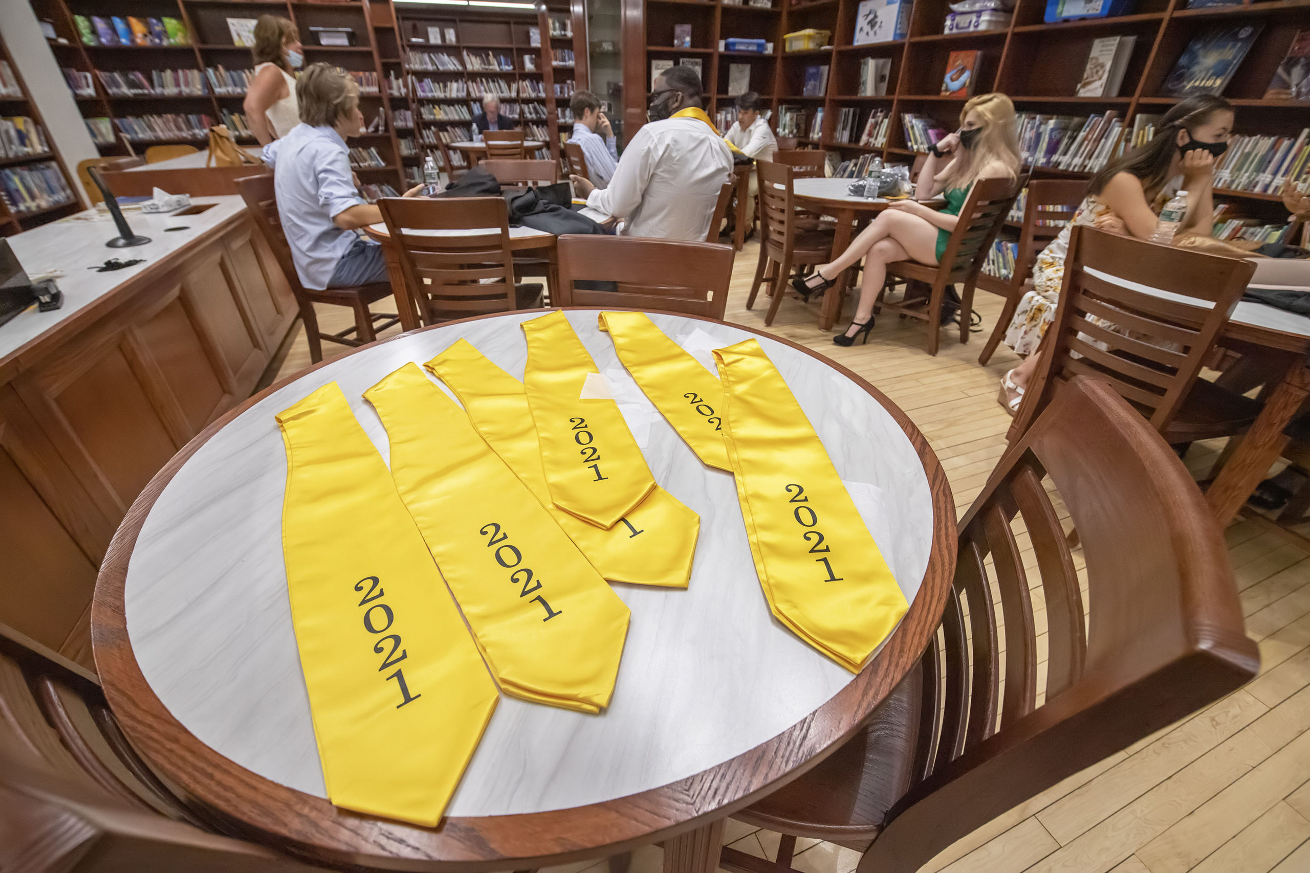 Bridgehampton School seniors wait in the school's new library prior to the start of their 2021 commencement ceremony on Saturday.   MICHAEL HELLER