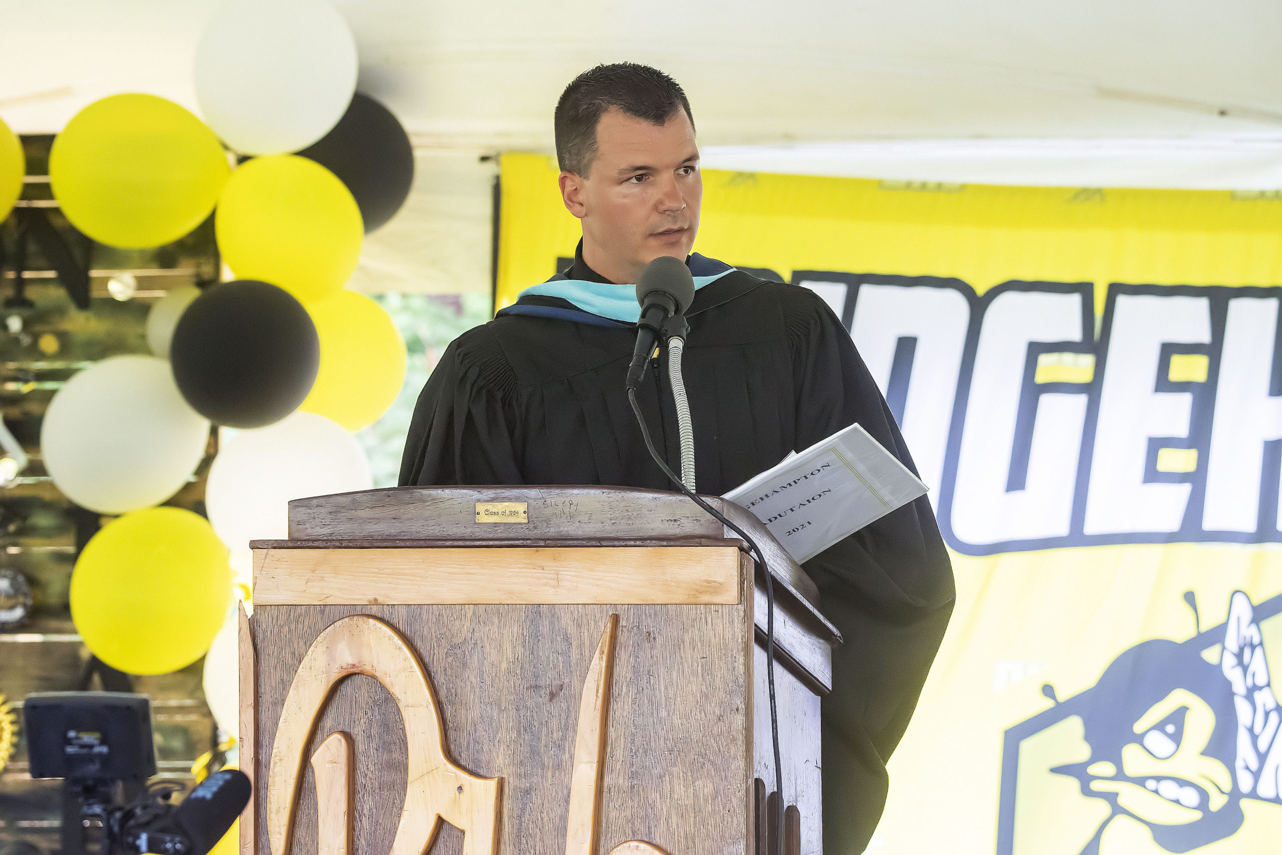 Bridgehampton School Principal Mike Miller addresses the crowd during the school's 2021 commencement ceremony on Saturday.    MICHAEL HELLER