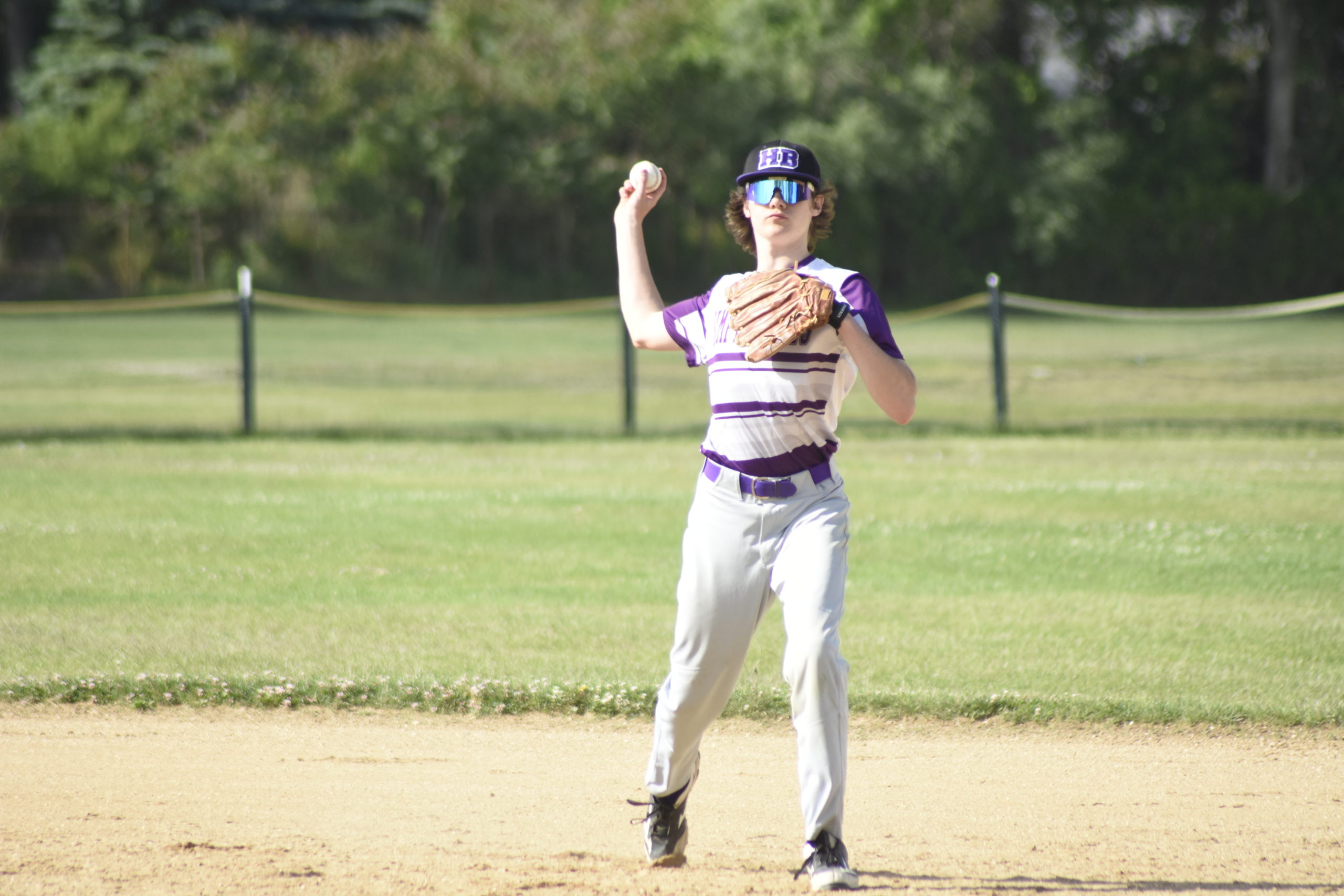 After fielding a ground ball, Hampton Bays second baseman Aidan Kamp throws to first for an out.