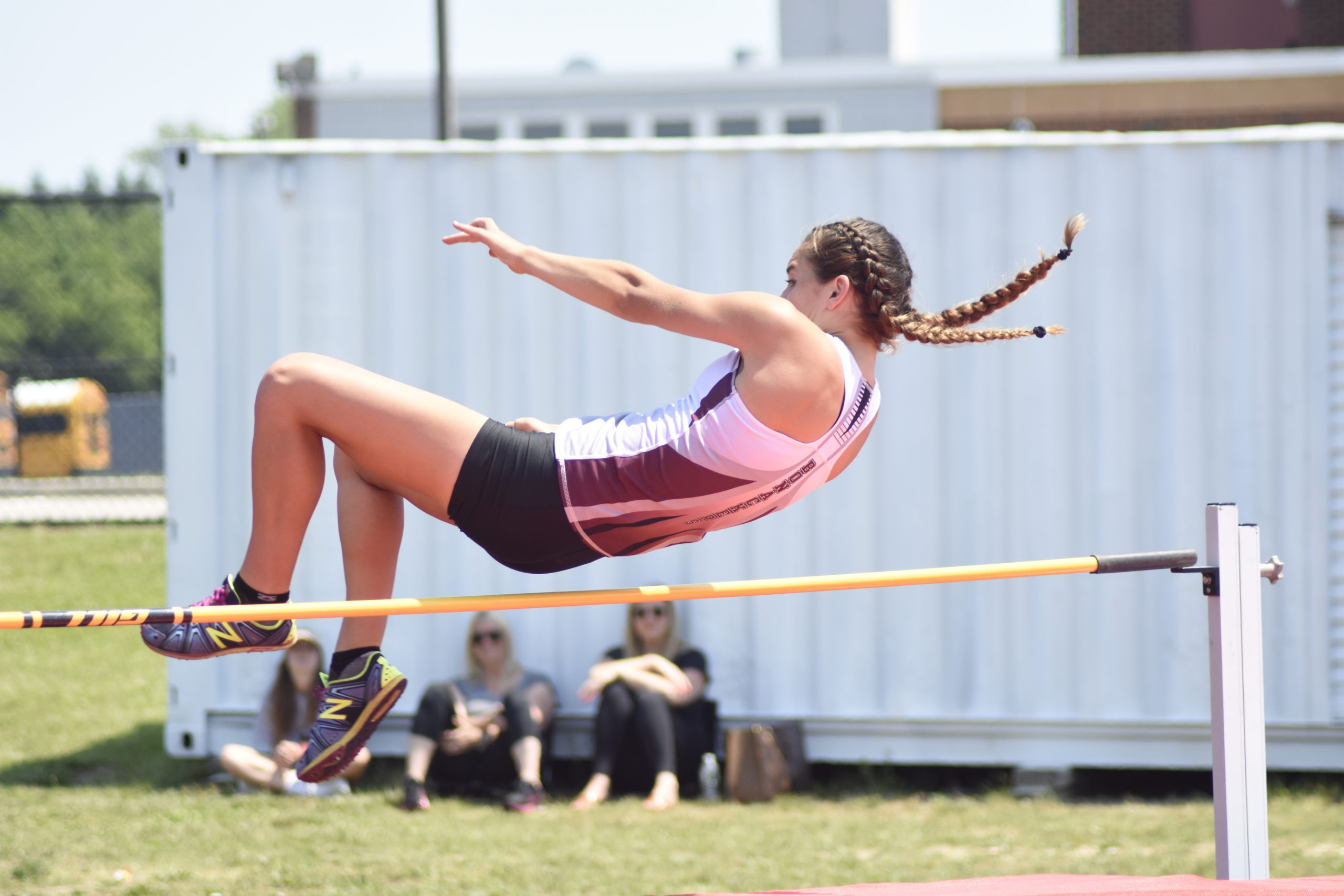 East Hampton senior Bella Tarbet clears the bar in the high jump of the pentathlon.