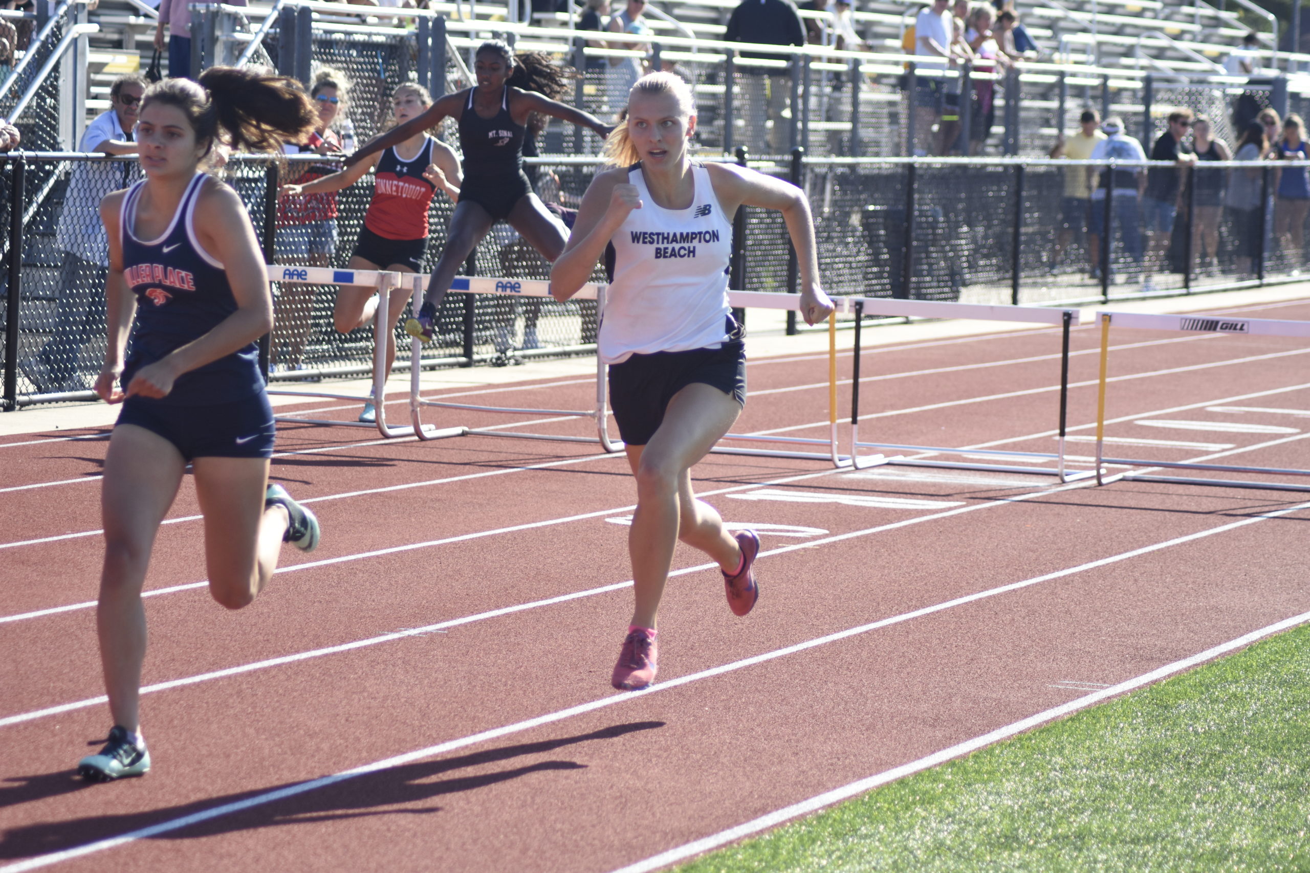 Westhampton Beach junior Valerie Finke running down the final stretch of the 400-meter hurdles, which she placed third in.