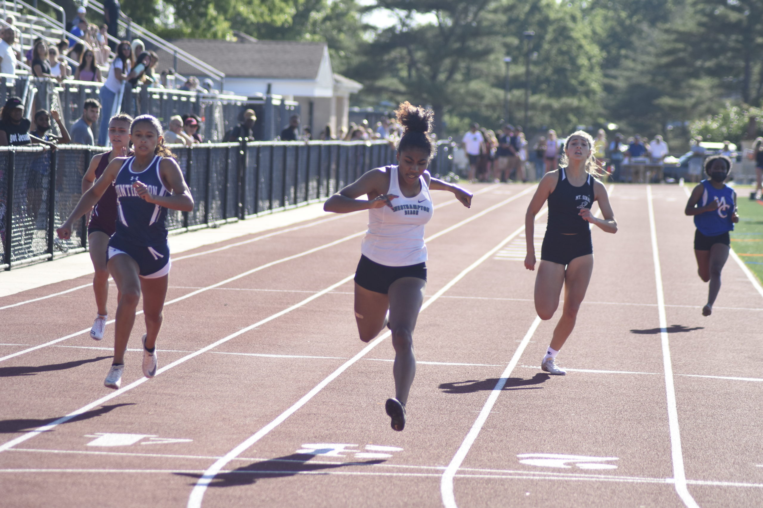 Westhampton Beach senior Oceane Ode crosses the finish line first in the 200-meter dash. She also won the 100-meter dash and was named Sprinter of the Year.