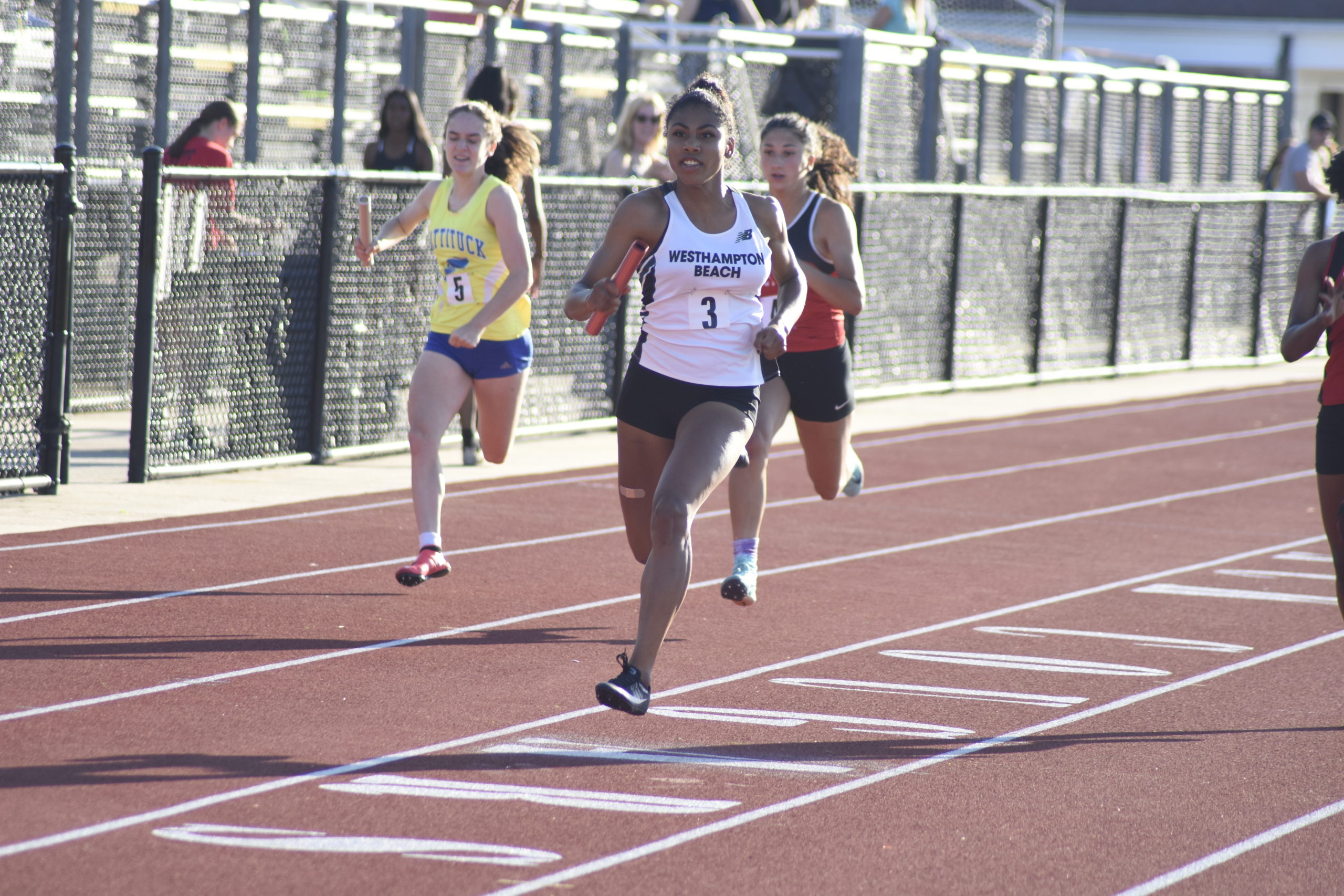 Oceane Ode finishing the final leg of the 4x100-meter dash which placed second at counties.