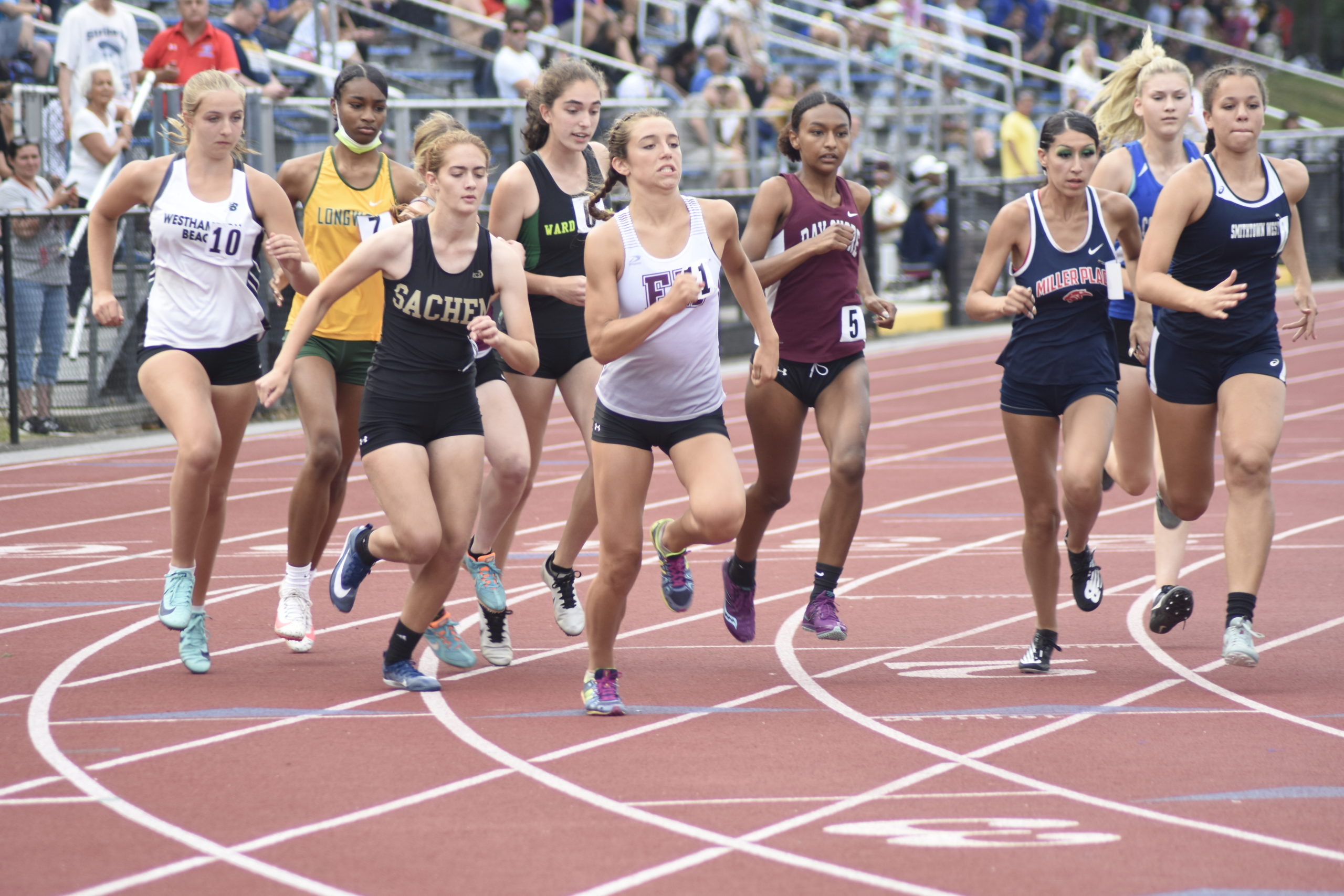 East Hampton senior Bella Tarbet darts over to the head of the pack at the start of the 800-meter run portion of the pentathlon.