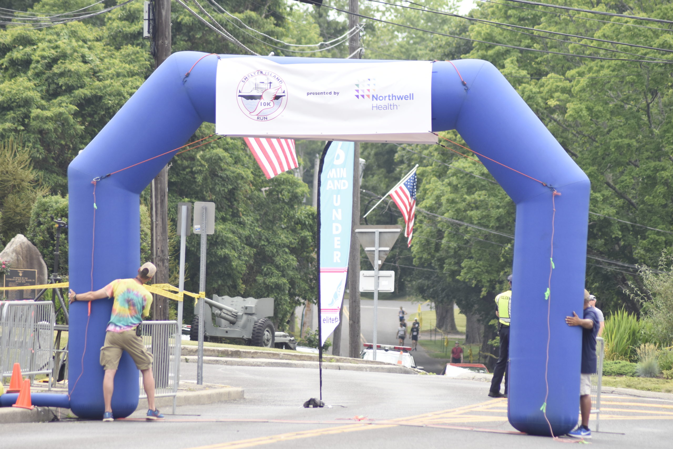 Race officials start to put up the official gate of the Shelter Island 10K just prior to the start of the race.