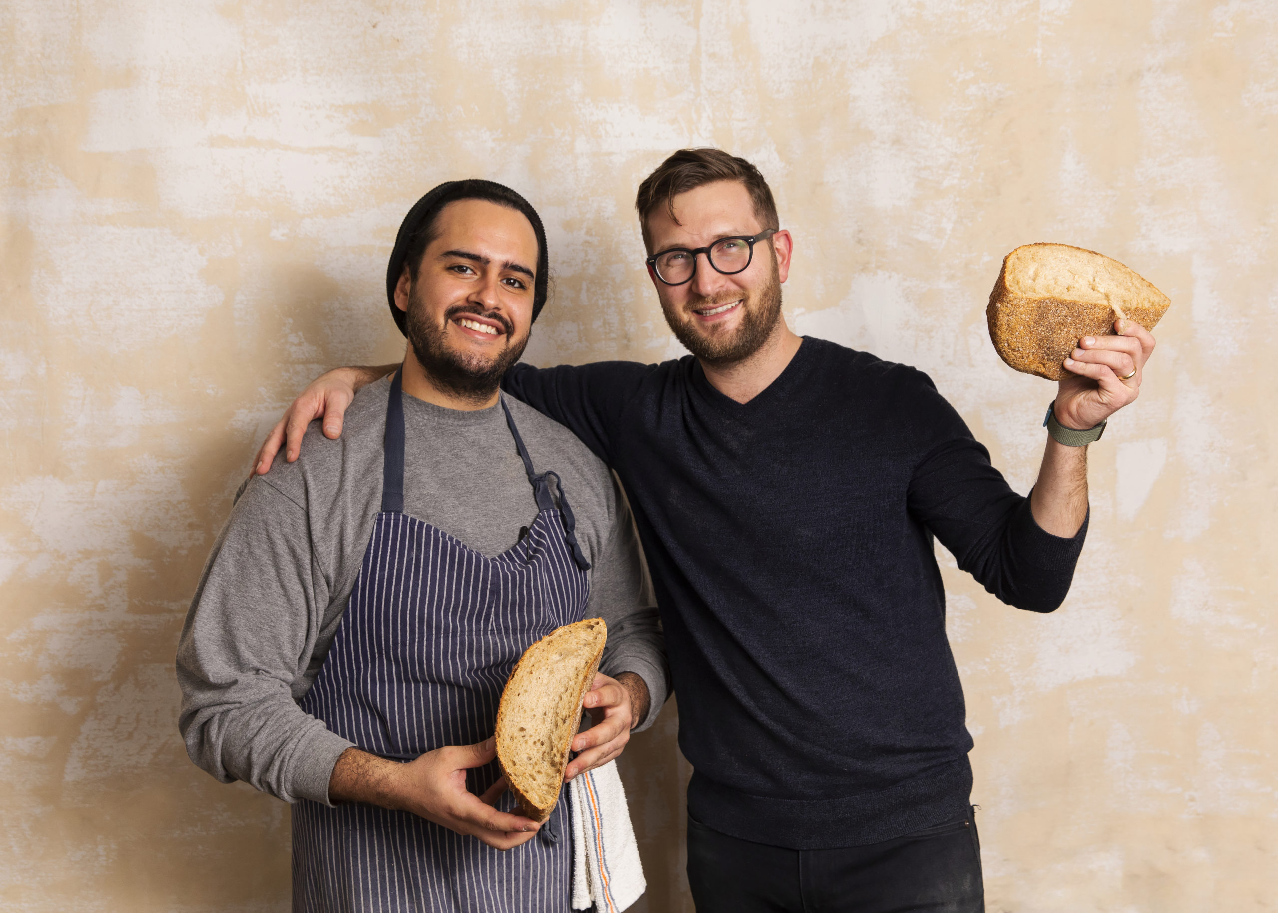 Head baker Carlos Barbosa and founder and CEO Stephen Robinson with some of their famous bread.