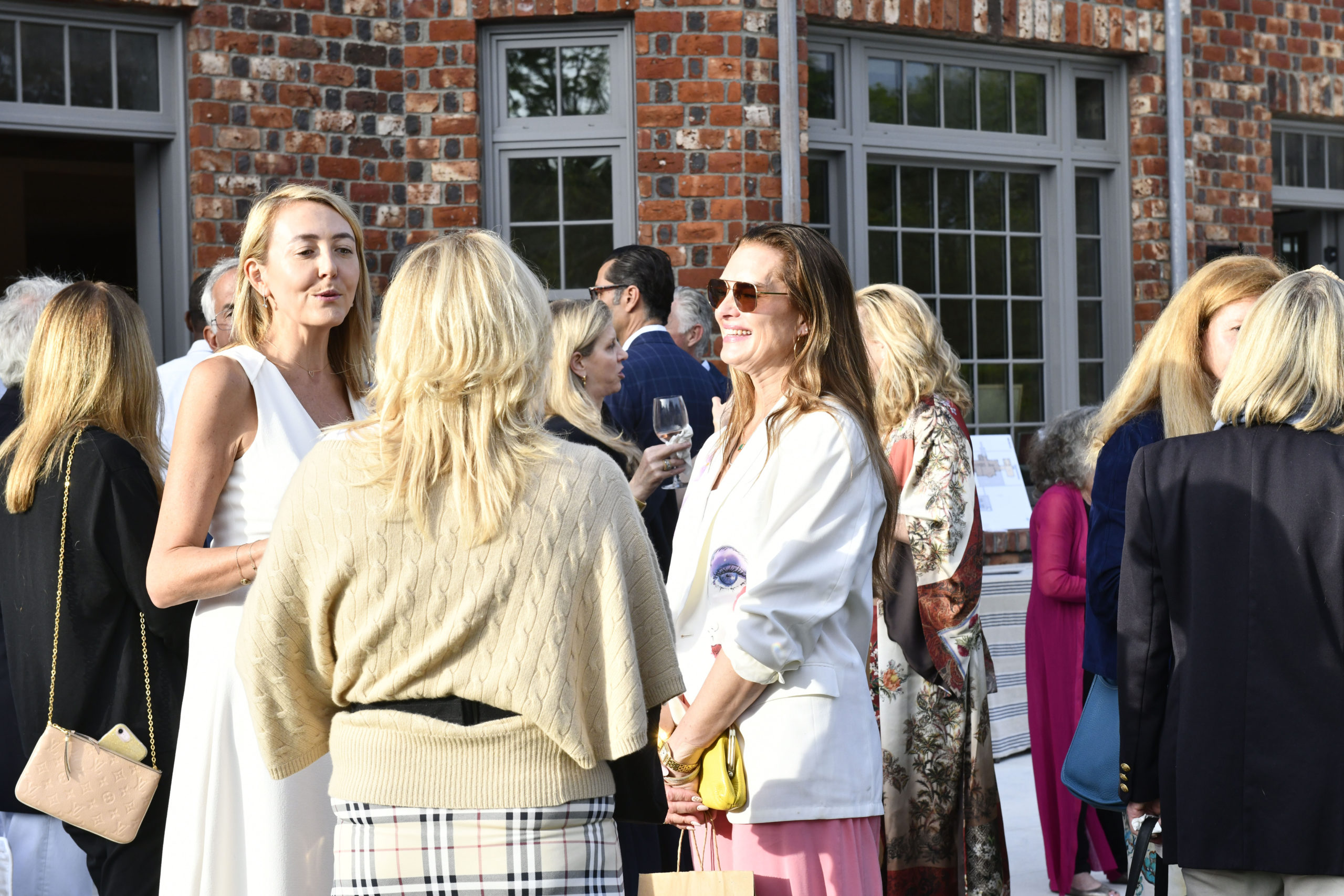 Local and celebrity guests, like, Brooke Shields, left, at the event at the newly restored Grosvenor Atterbury Estate in Southampton Village on June 12.  DANA SHAW