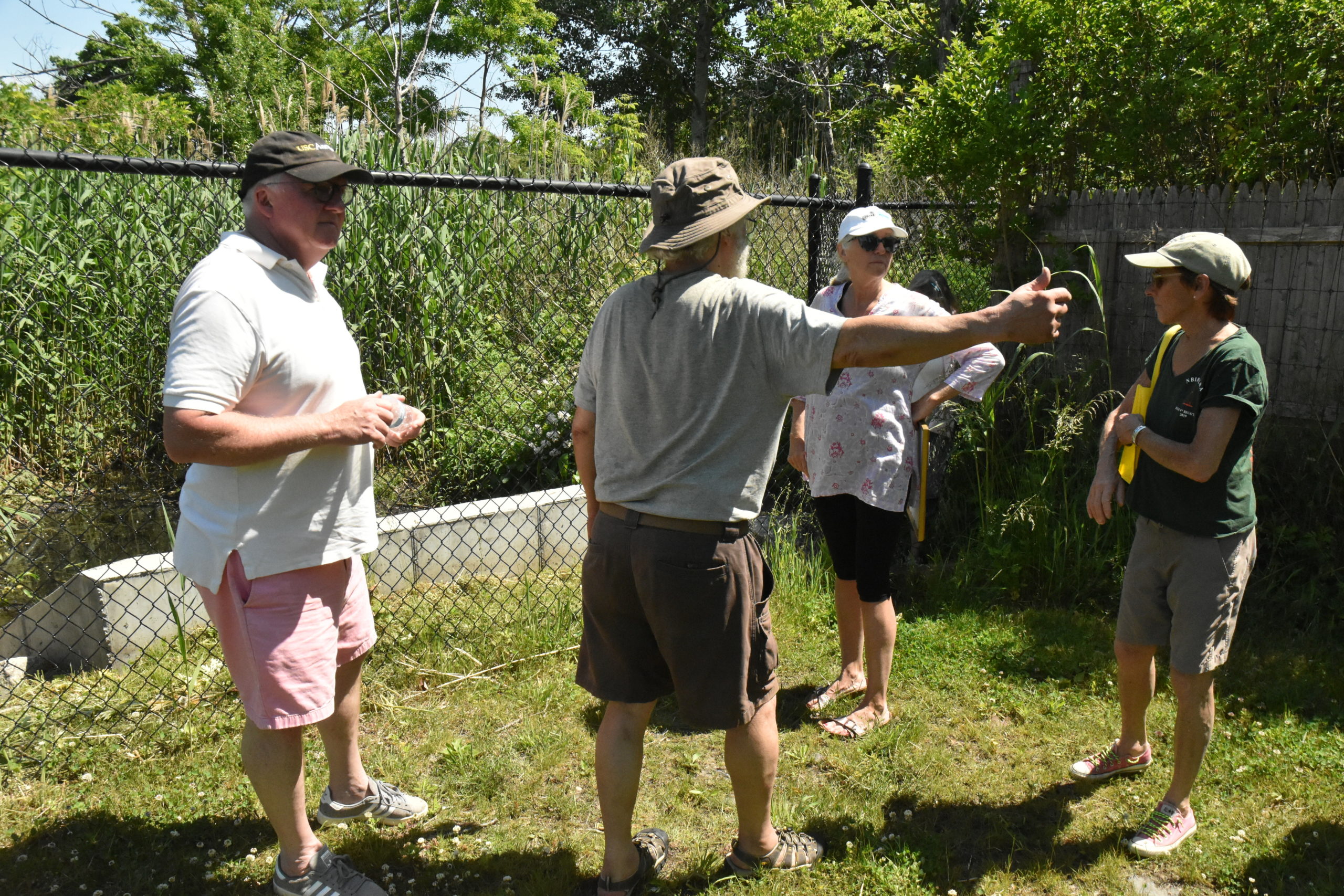 Harbor Committee member John Parker discusses the Havens Beach drainage system with Mayor Kathleen Mulcahy and Trustee Aidan Corish. STEPHEN J. KOTZ