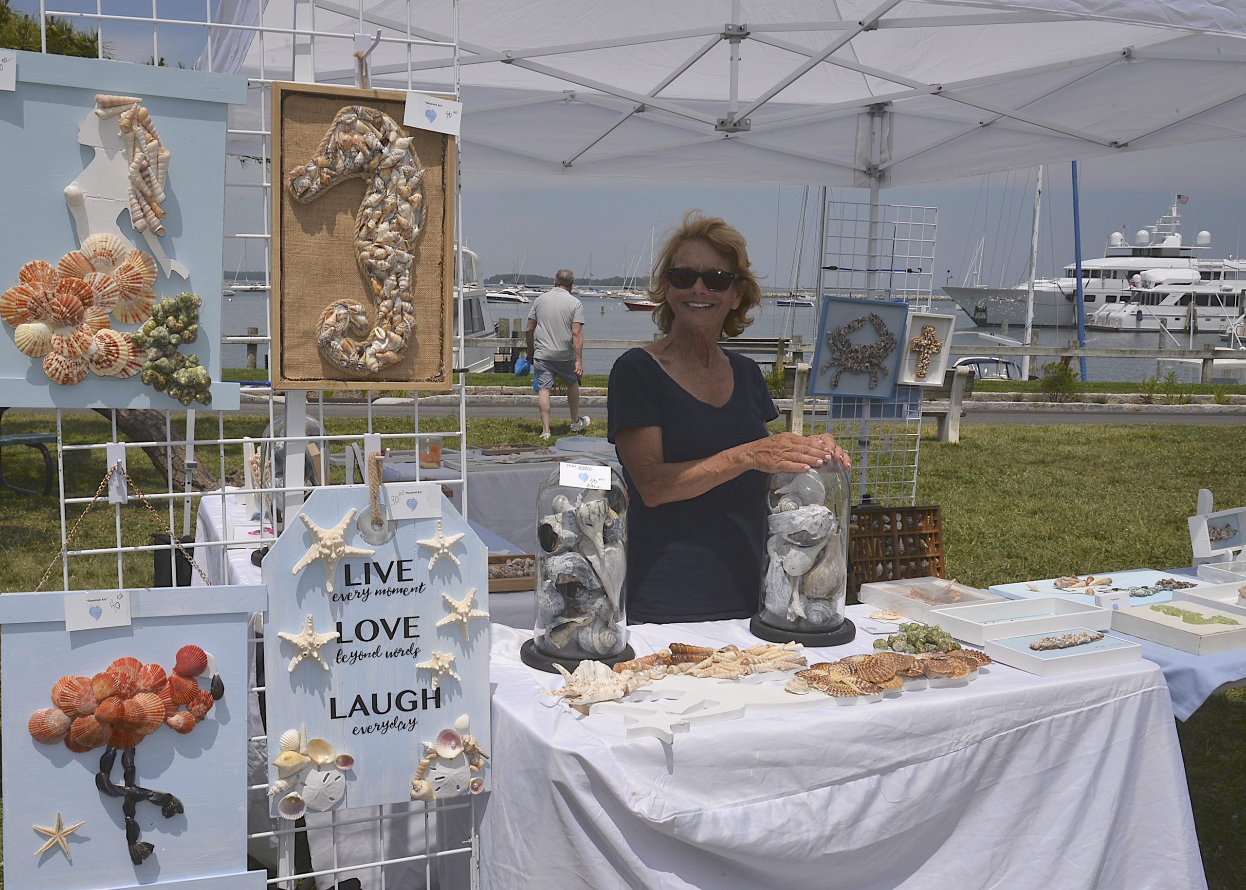 Gail Cunningham of  Shellebration with her seashell creations at the Sag Harbor Arts and Crafts Fair in Marine Park on Saturday.     KYRIL BROMLEY