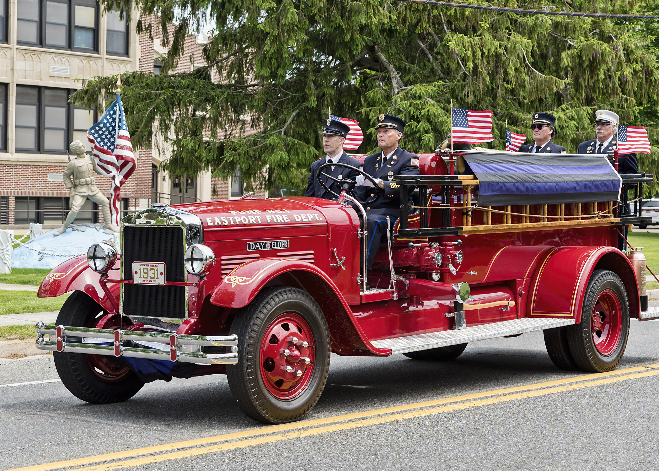 The Eastport Fire Department’s antique pumper carries the remains of Eastport Fire Department ex-chief and 65-year member James “Jimmy” Baker past the Eastport Elementary School enroute to the cemetery last Wednesday morning.