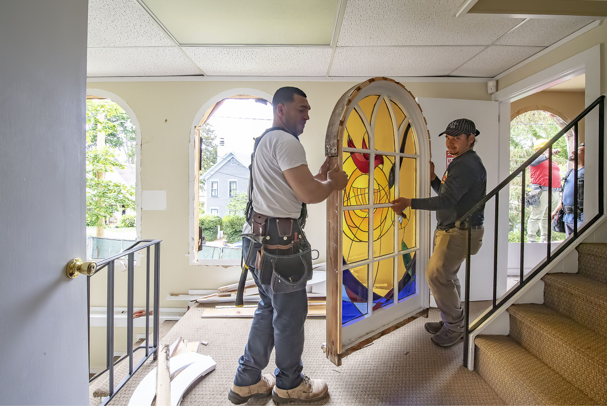 Stained glass windows are removed from Temple Adas Israel in Sag Harbor on June 21 as the Temple begins an expansion and restoration of the oldest synagogue on Long Island.