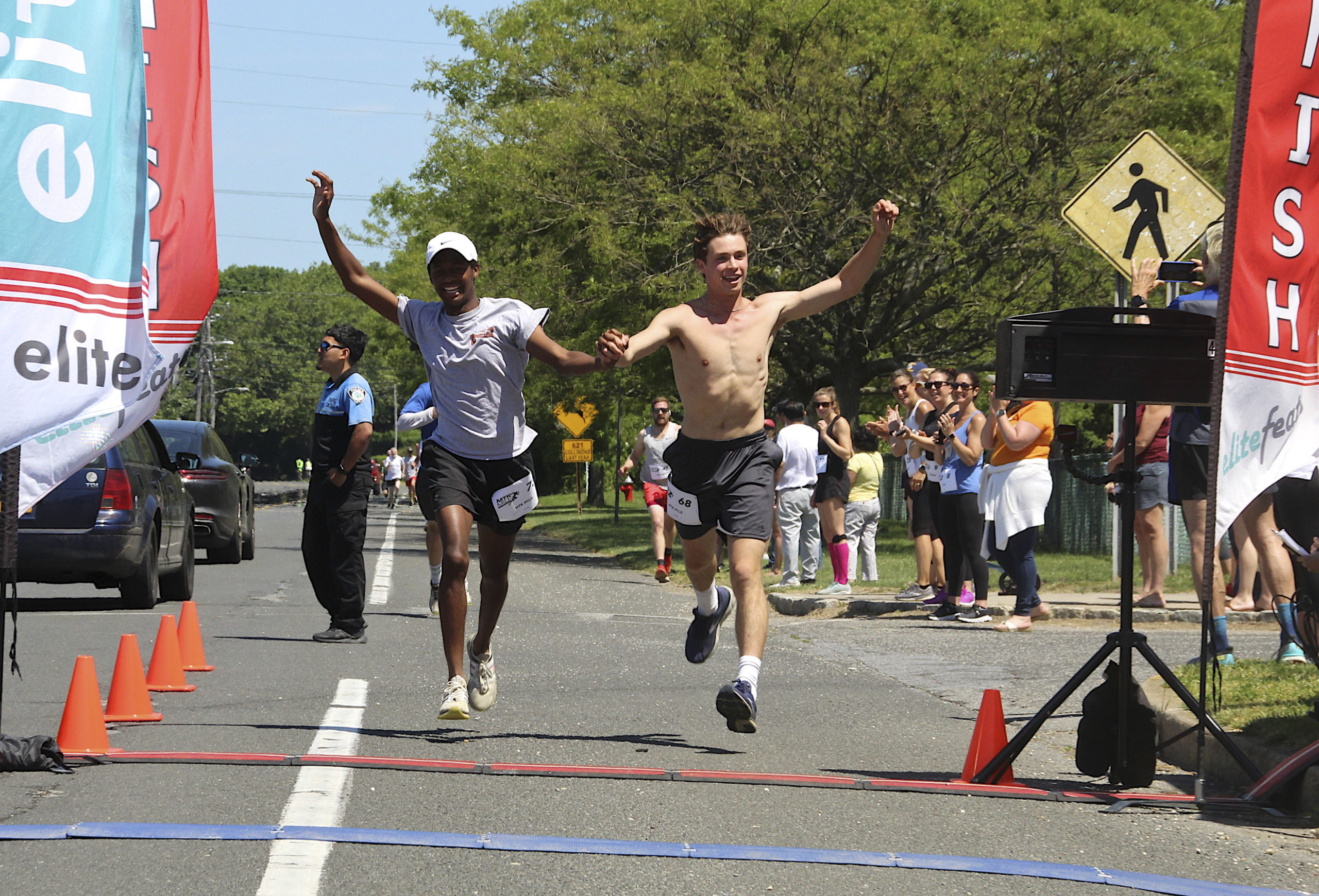 The third and fourth place finishers cross the line together. KYRIL BROMLEY