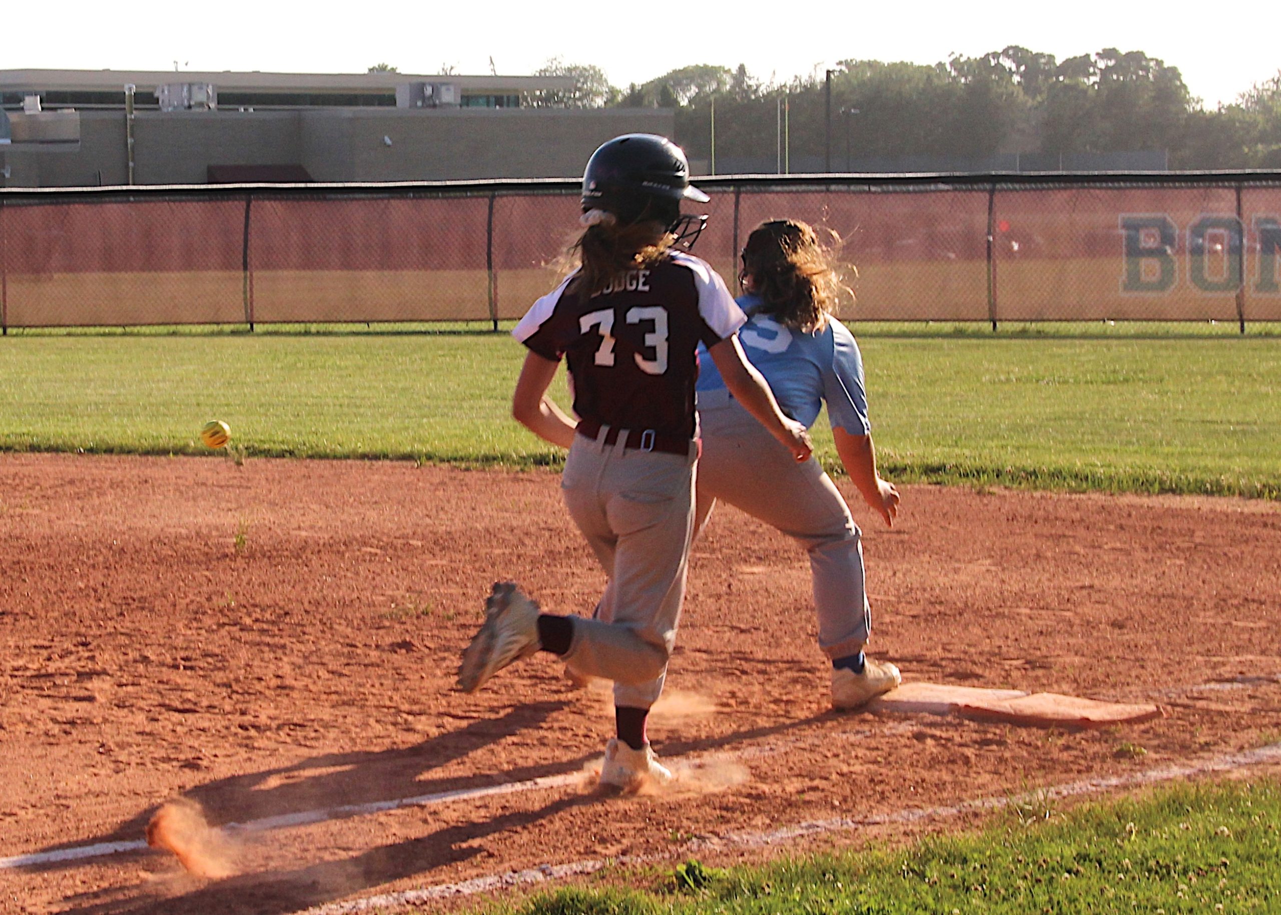 Olivia Dodge tries to beat out a throw to first base.