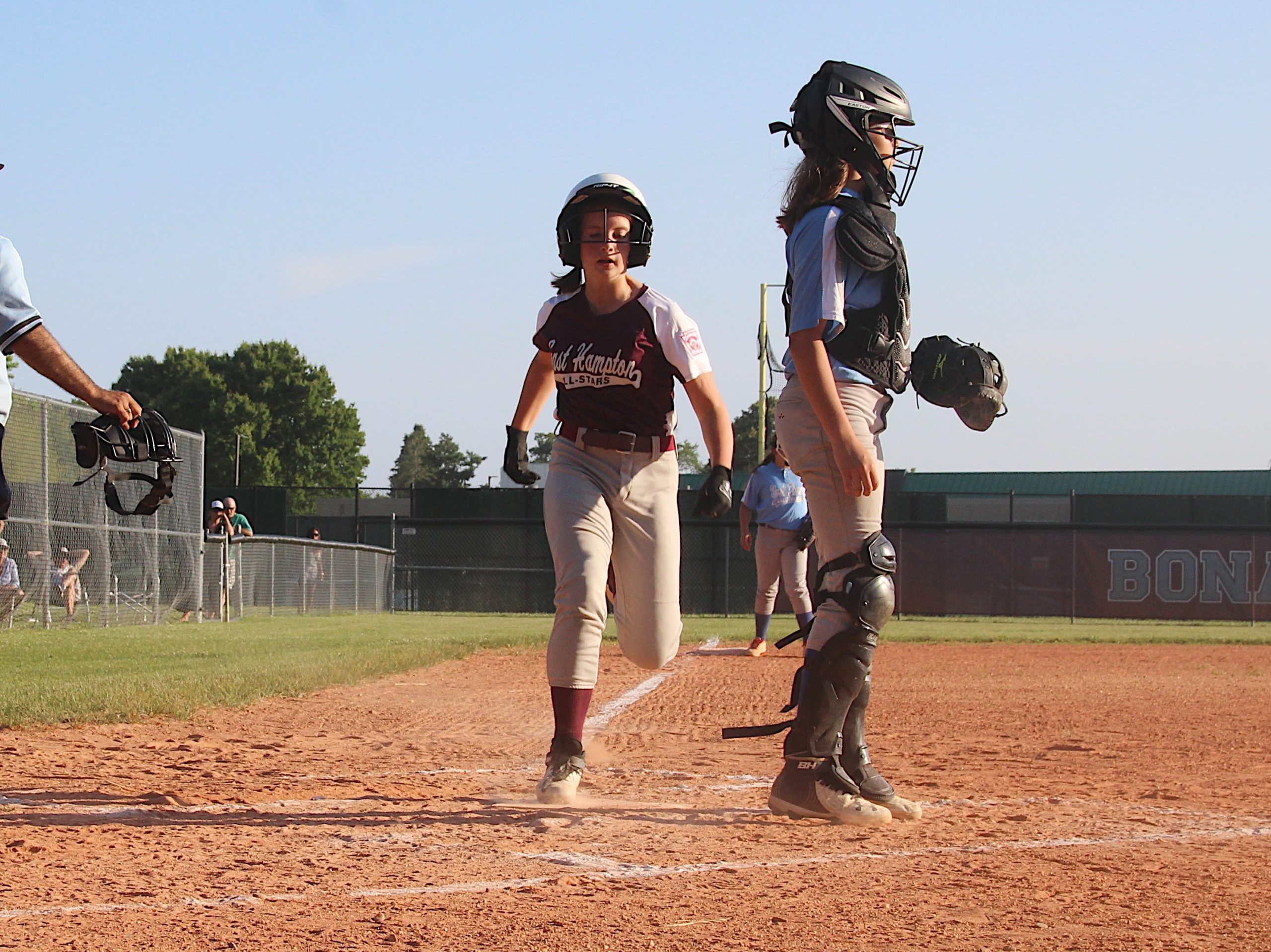 Paige Daniels crosses the plate for a run.