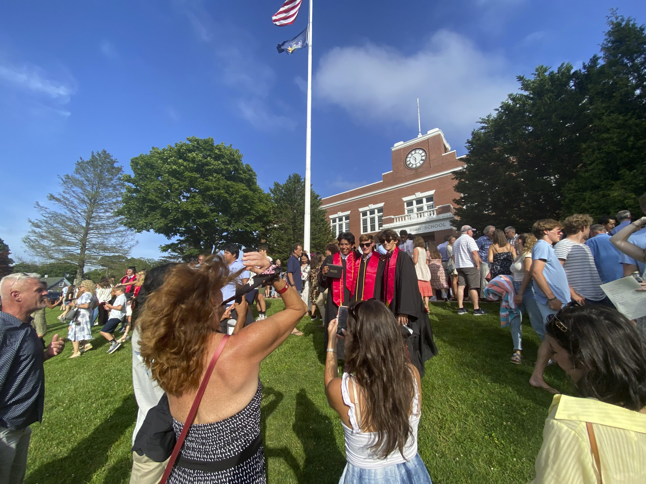 Family and friends take photos of the graduates.  DANA SHAW