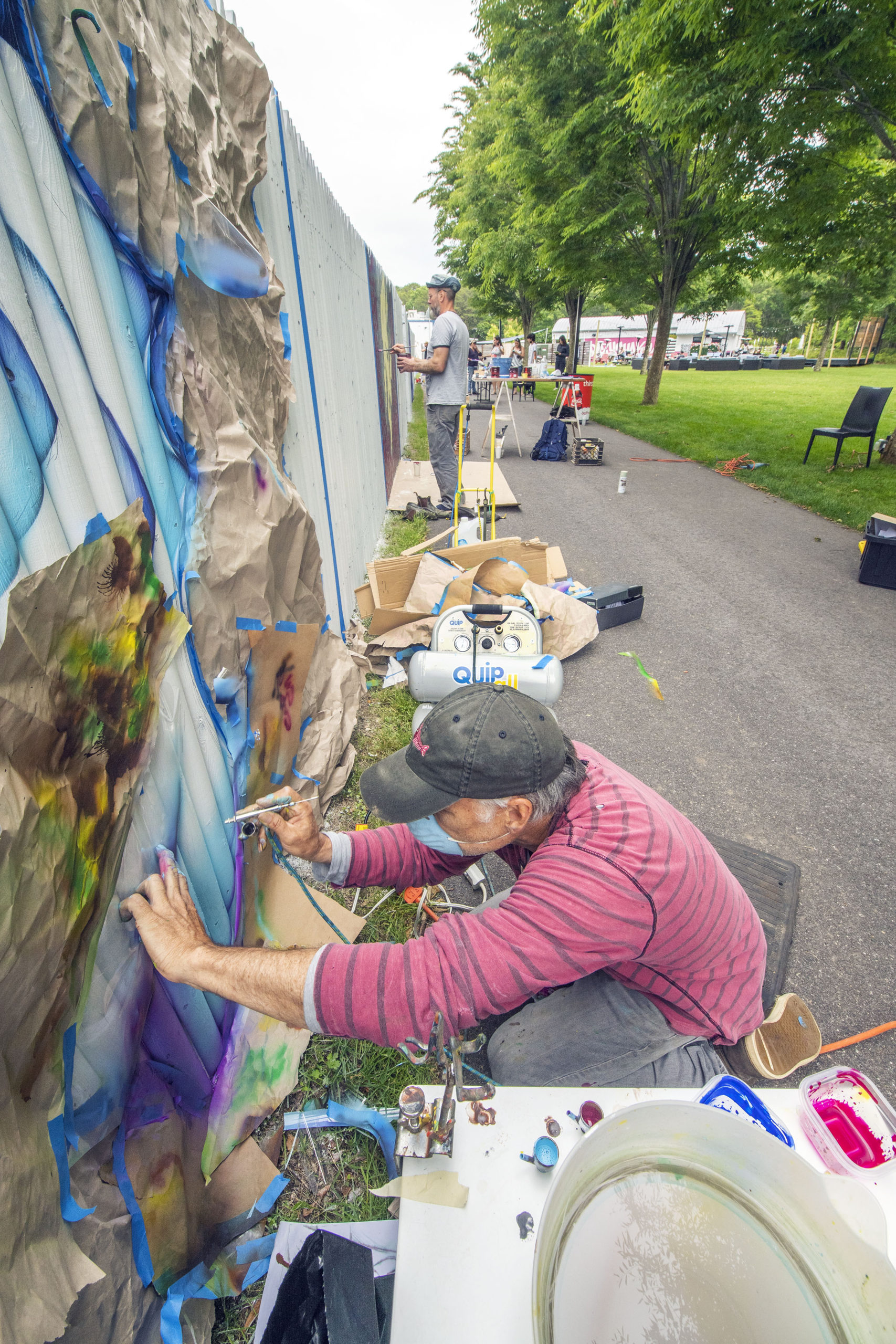 John Jinks uses an airbrush to create his entry during the Live Mural and Graffiti Competition at The Clubhouse on Saturday, June 12.