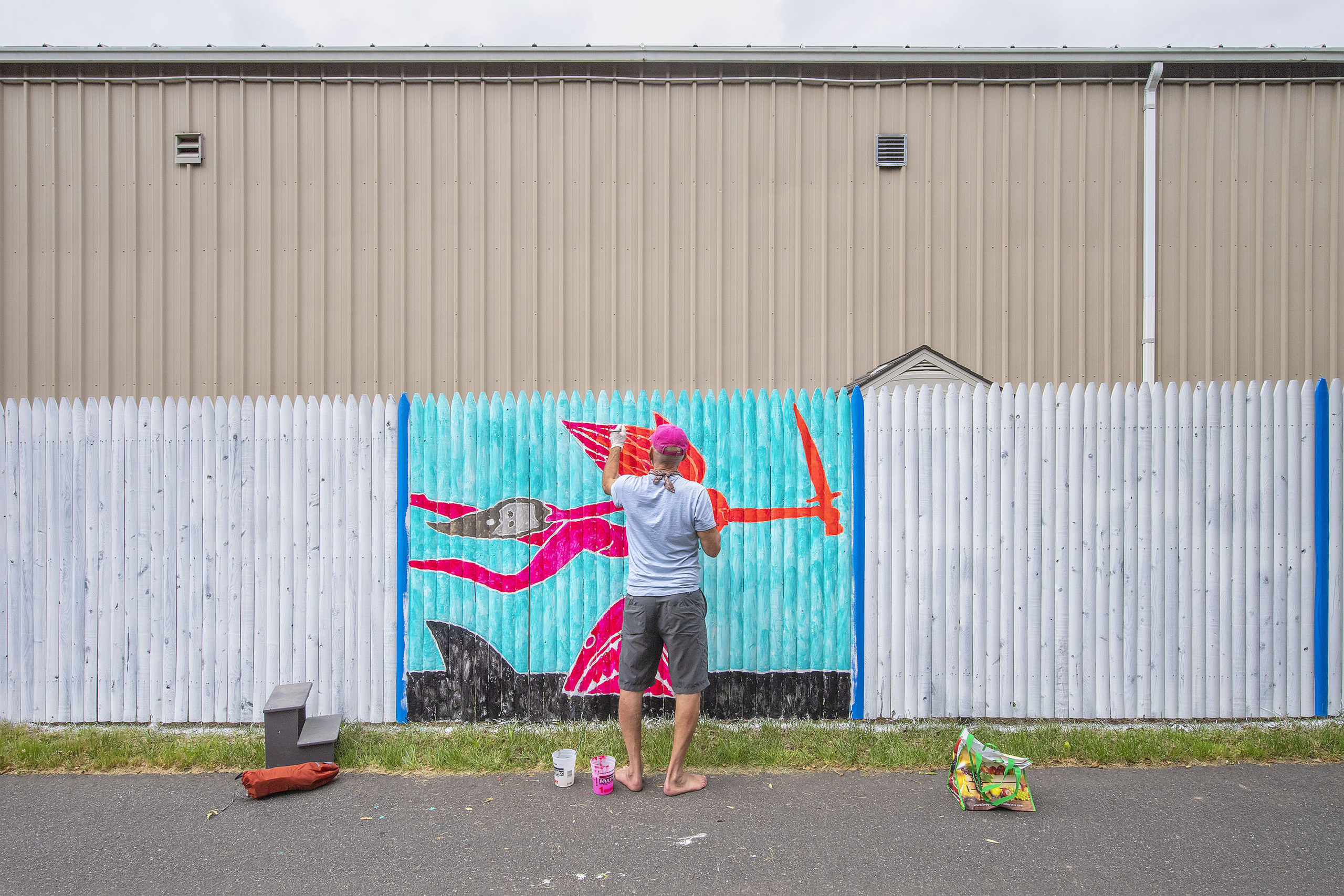 David Bender works on his entry — a variation on the story of Judith and Holofernes — during the Live Mural and Graffiti Competition at The Clubhouse on Saturday, June 12.