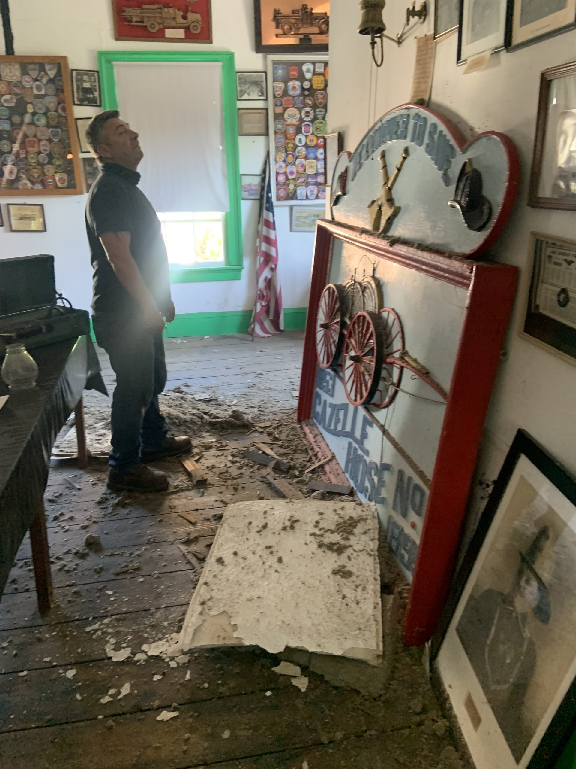 Sag Harbor Village Trustee Tom Gardella inspects damage from a leaky roof at the Sag Harbor Fire Department Museum. STEPHEN J. KOTZ