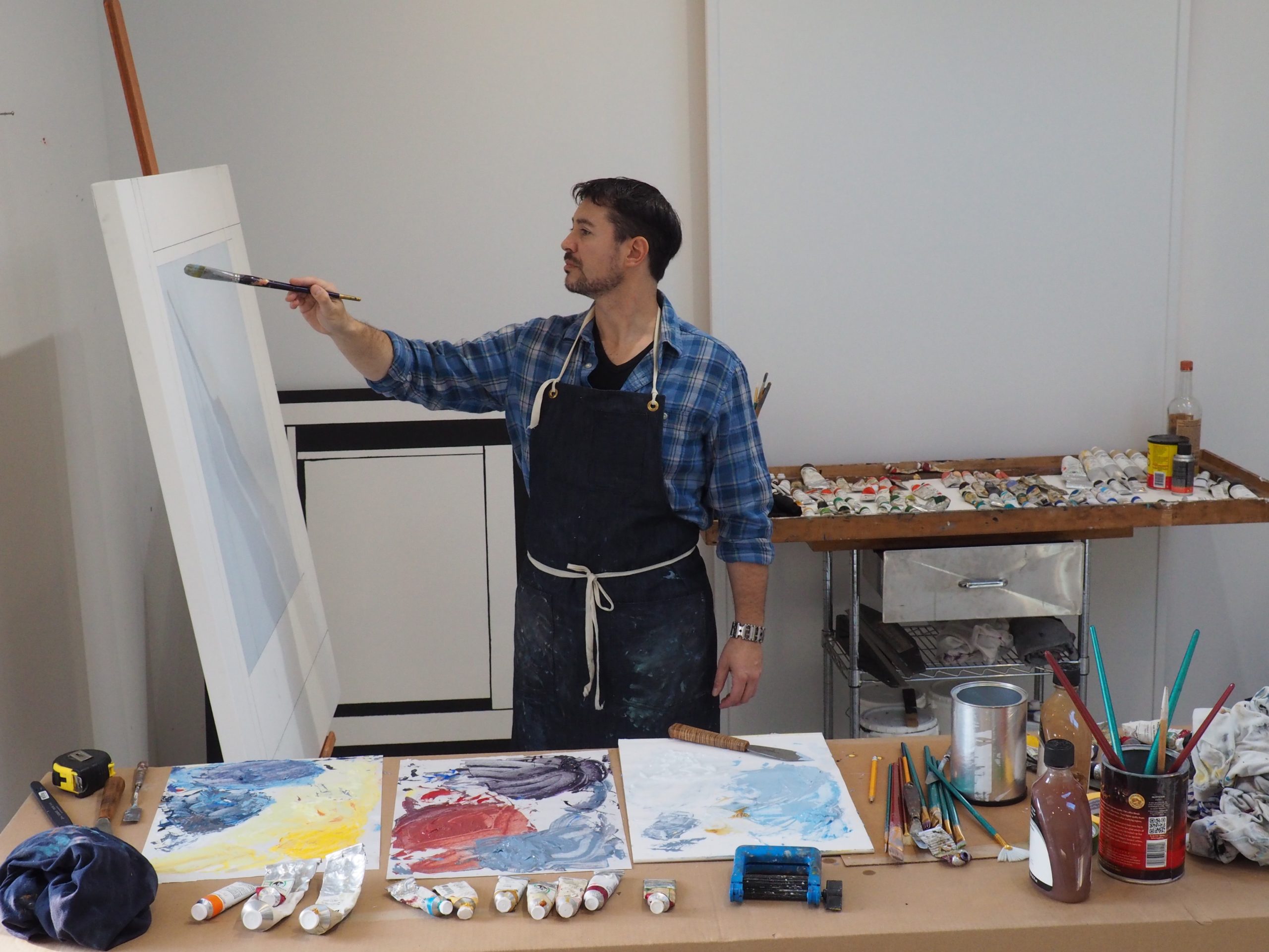 Artist Chris Kelly works on a painting in his studio.