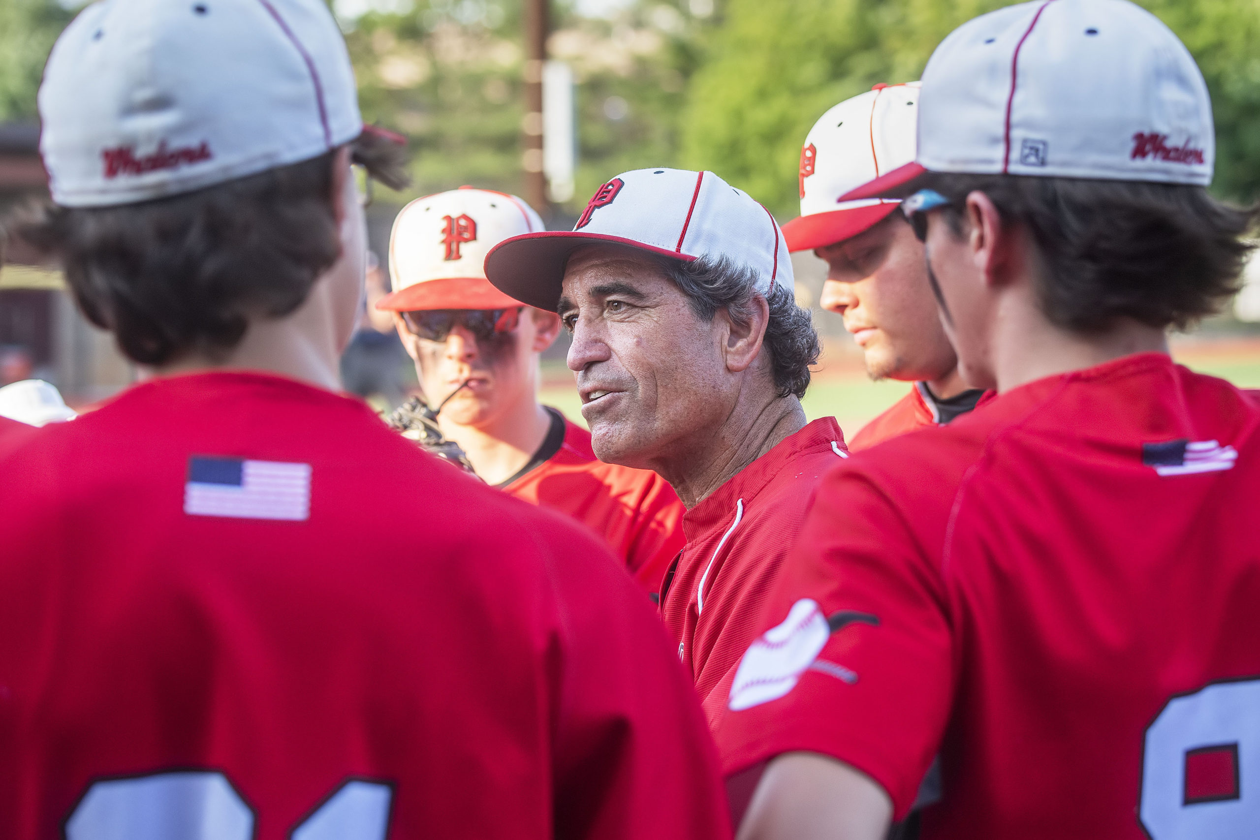 Pierson assistant coach Benito Vila gives the team a pep talk after a rough inning.
