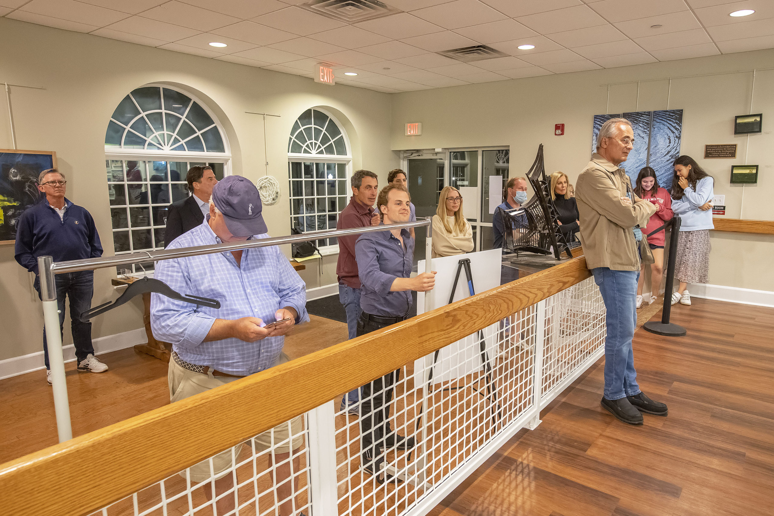A gallery of interested persons watches from outside the main room as the vote count from each of the voting machines is tabulated during the 2021 Southampton Village Mayoral election at the Southampton Cultural Center on Friday night. MICHAEL HELLER