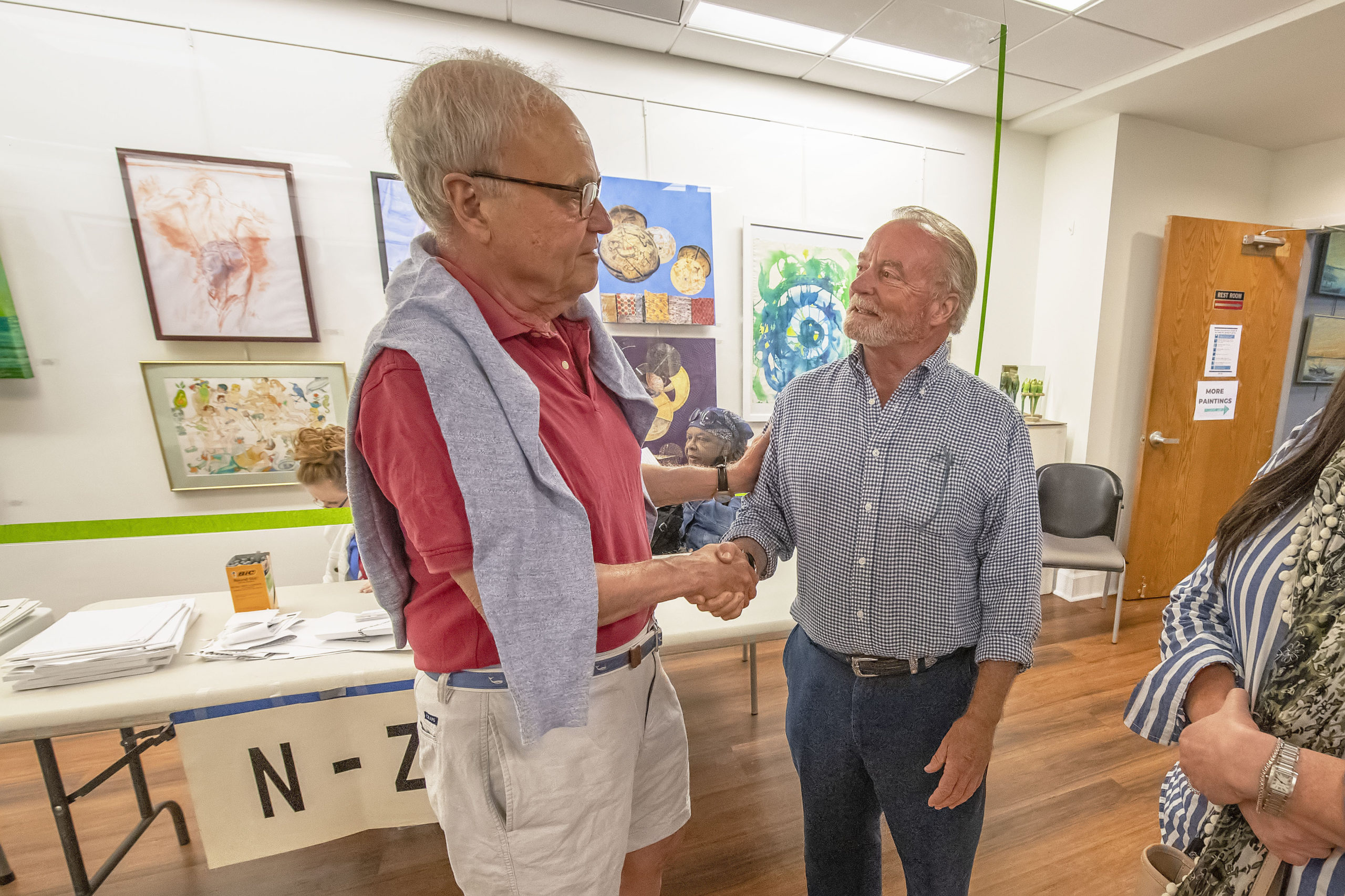 Mayoral candidate Michael Irving gets a handshake from a supporter in spite of his loss following the 2021 Southampton Village Mayoral election at the Southampton Cultural Center on Friday night. MICHAEL HELLER
