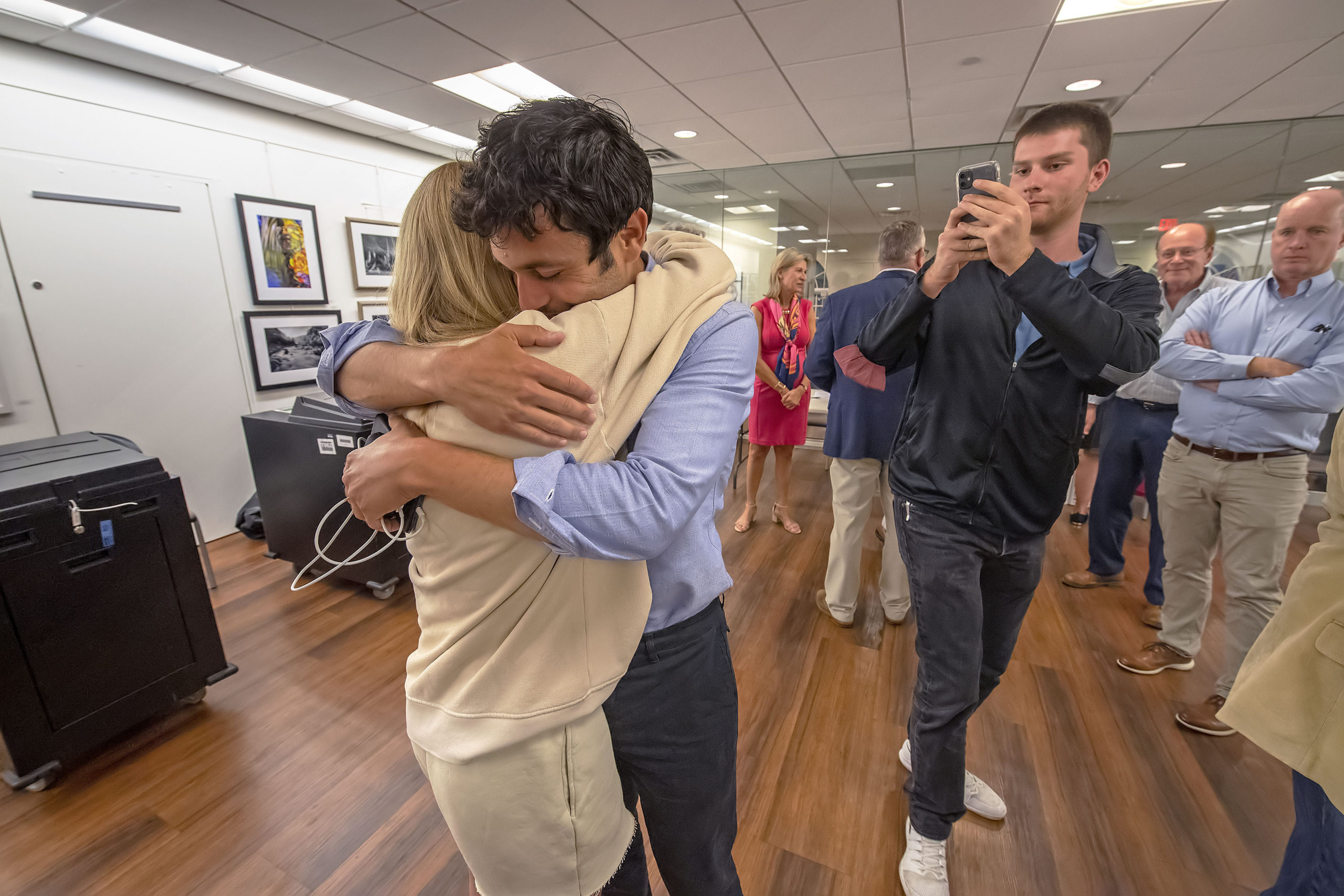 As his communications director takes some video, newly-re-elected Southampton Village Mayor Jesse Warren gets a long hug from his girlfriend Martyna Sokol following the 2021 Southampton Village Mayoral election at the Southampton Cultural Center on Friday night. MICHAEL HELLER