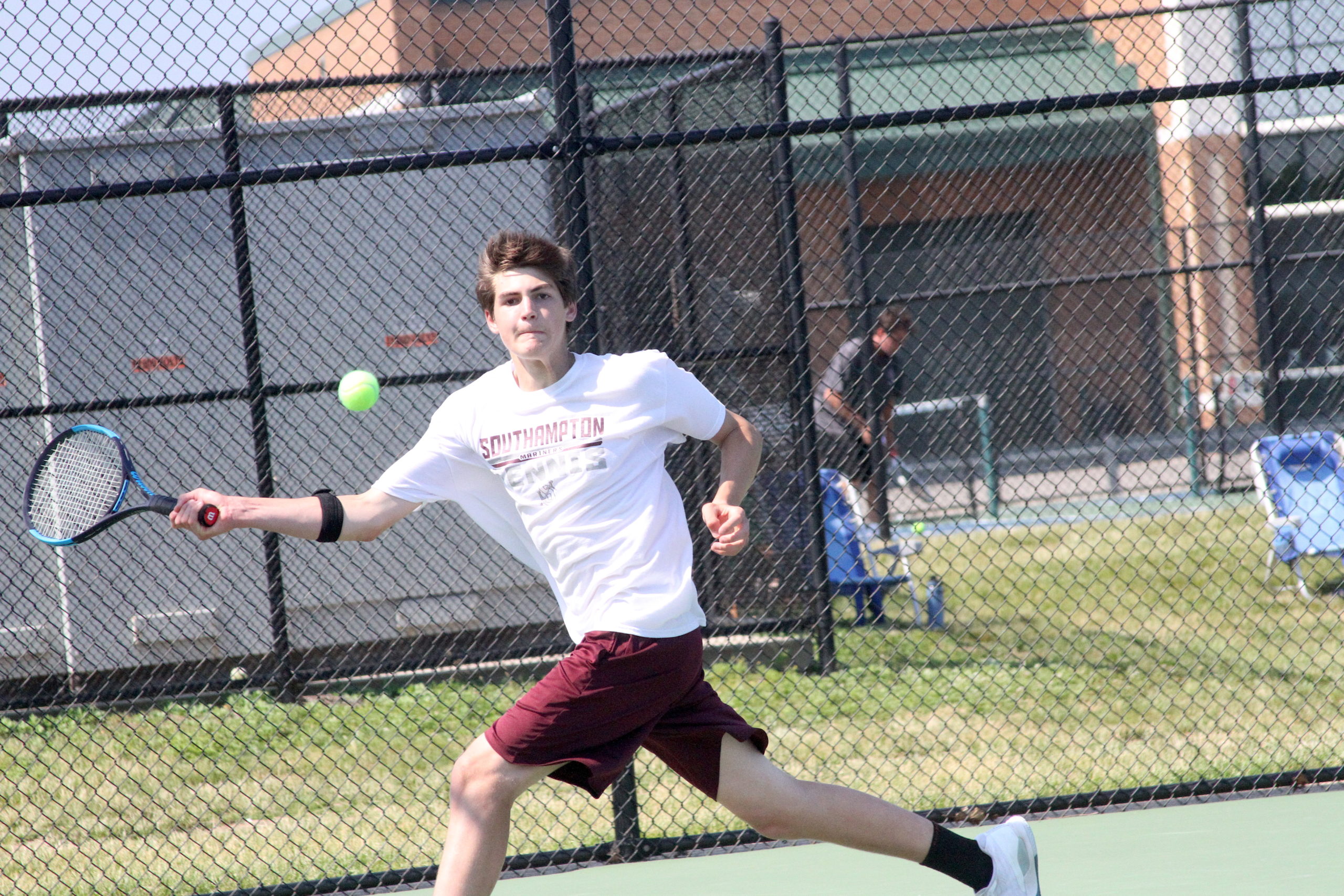 Southampton junior Luke Sacconaghi returns a serve during his doubles team's Division IV semifinal match. DESIRÉE KEEGAN