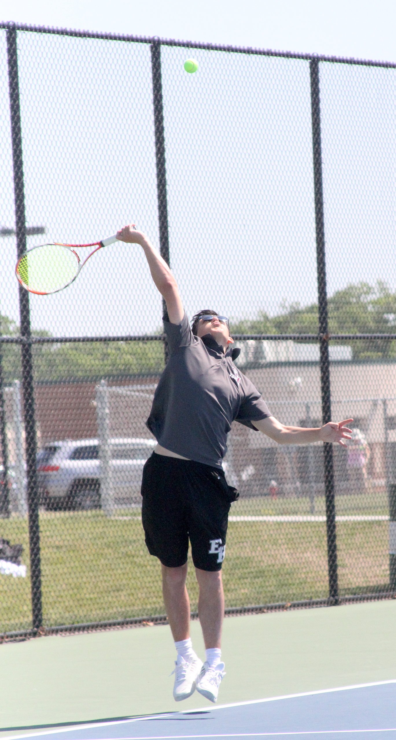 Pierson junior Jackson LaRose serves for East Hampton in the semifinals of the Division IV doubles tournament. DESIRÉE KEEGAN