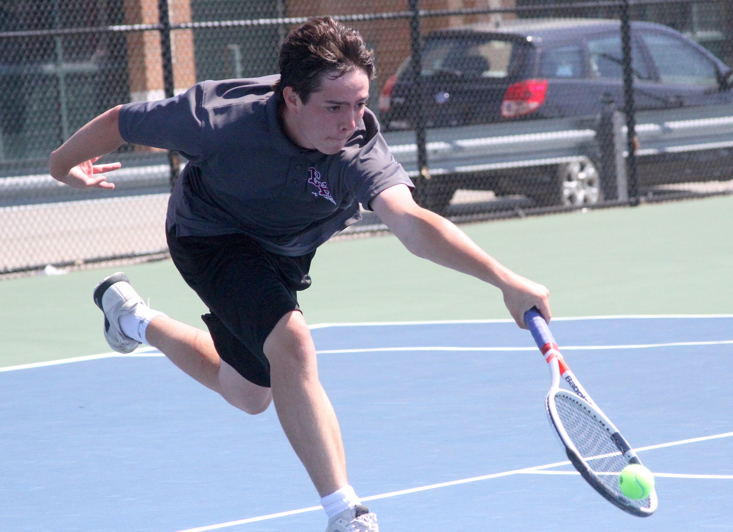East Hampton freshman Nick Cooper races to return the ball in his Division IV quarterfinals match. DESIRÉE KEEGAN