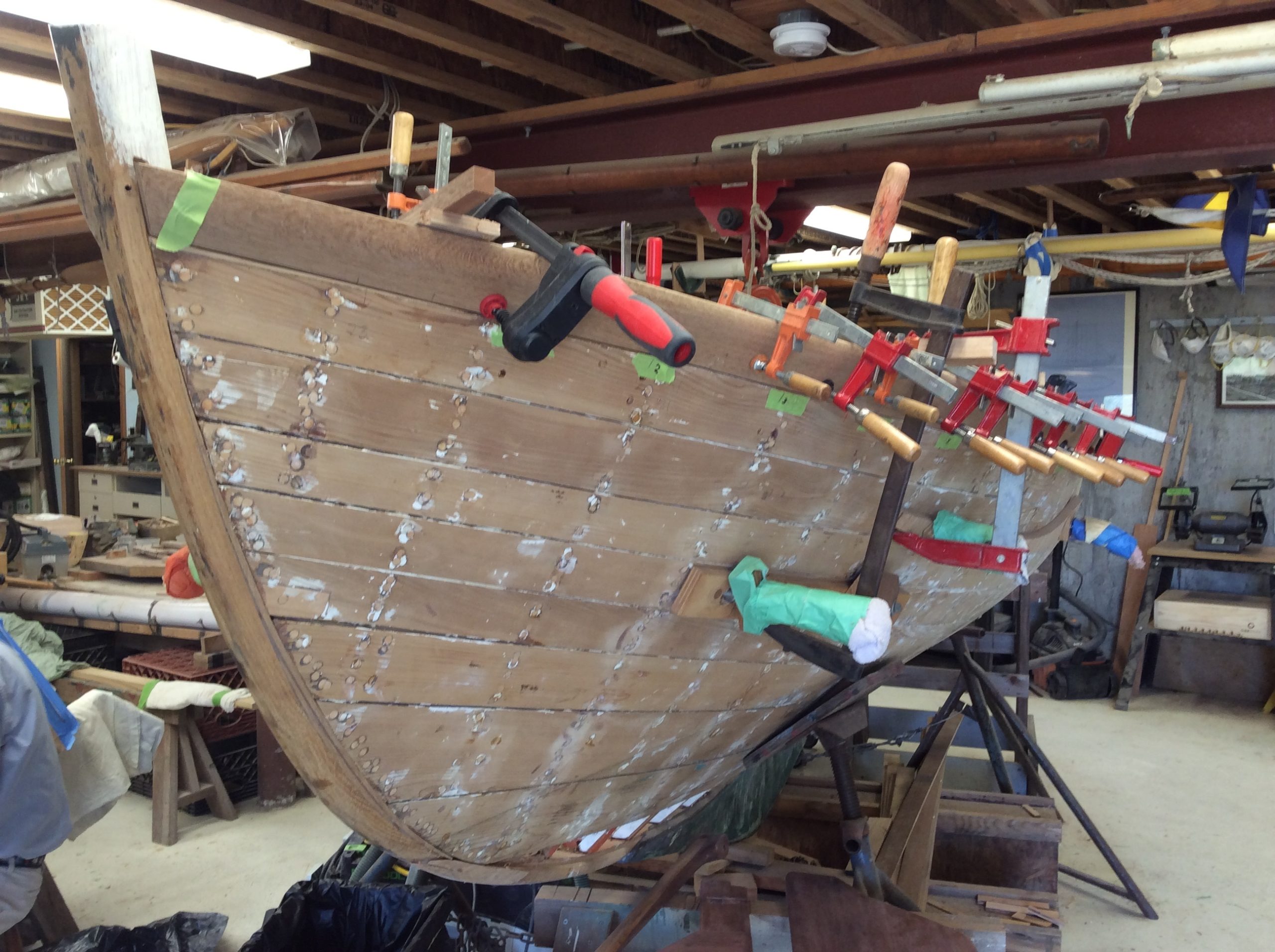 Volunteers have clamped the Tern sheer strake, or the wooden panels on the exterior of the vessel. BRYAN BOYHAN