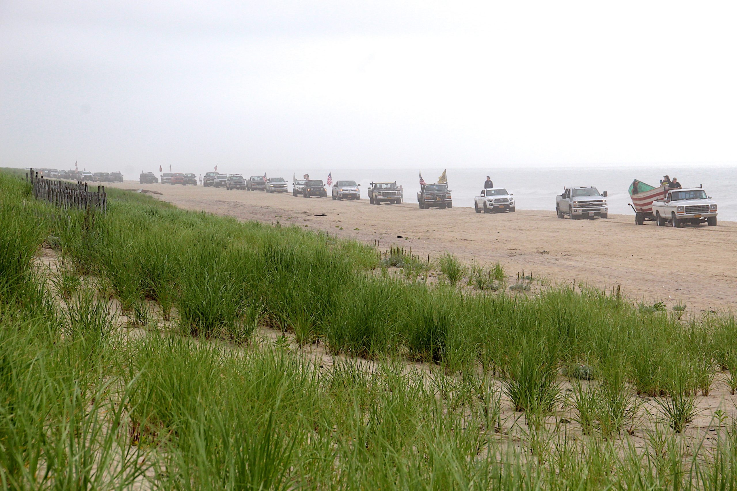 Dozens of trucks paraded onto the beach in Amagansett on Sunday morning in protest of a court ruling declaring the beach privately owned.