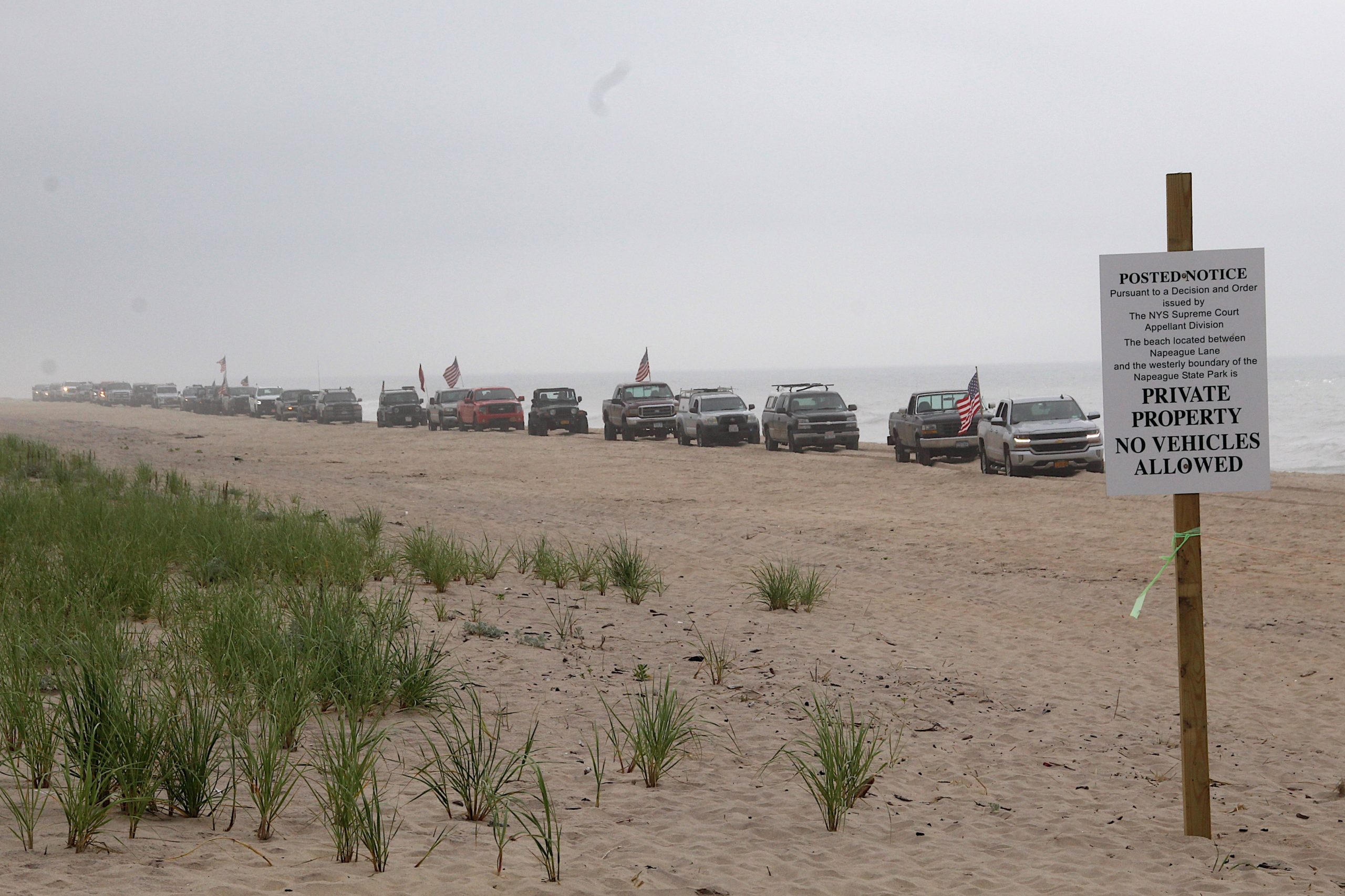 Dozens of trucks paraded onto the beach in Amagansett on Sunday morning in protest of a court ruling declaring the beach privately owned.