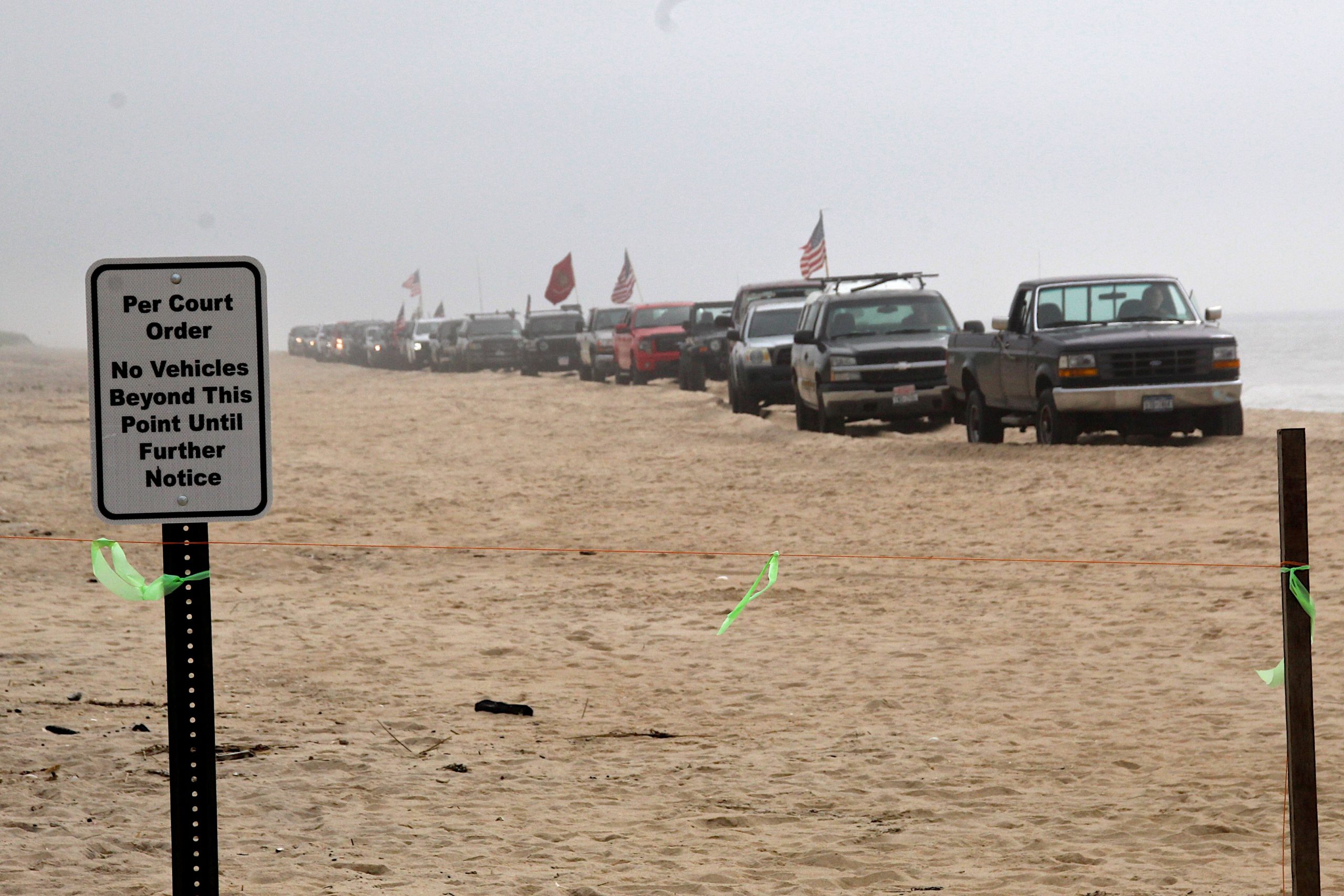 Dozens of trucks paraded onto the beach in Amagansett on Sunday morning in protest of a court ruling declaring the beach privately owned.