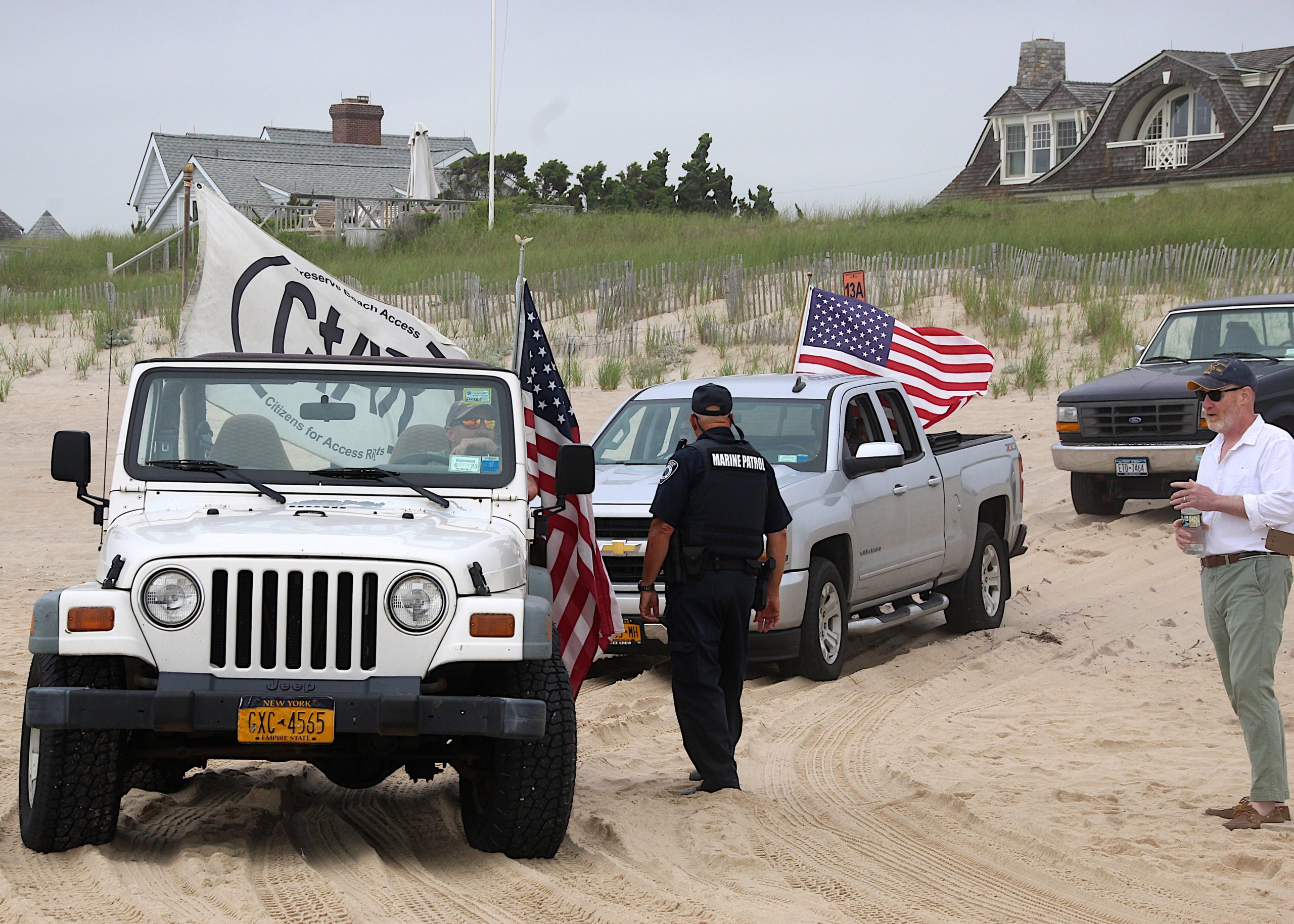 Dozens of trucks paraded onto the beach in Amagansett on Sunday morning in protest of a court ruling declaring the beach privately owned.