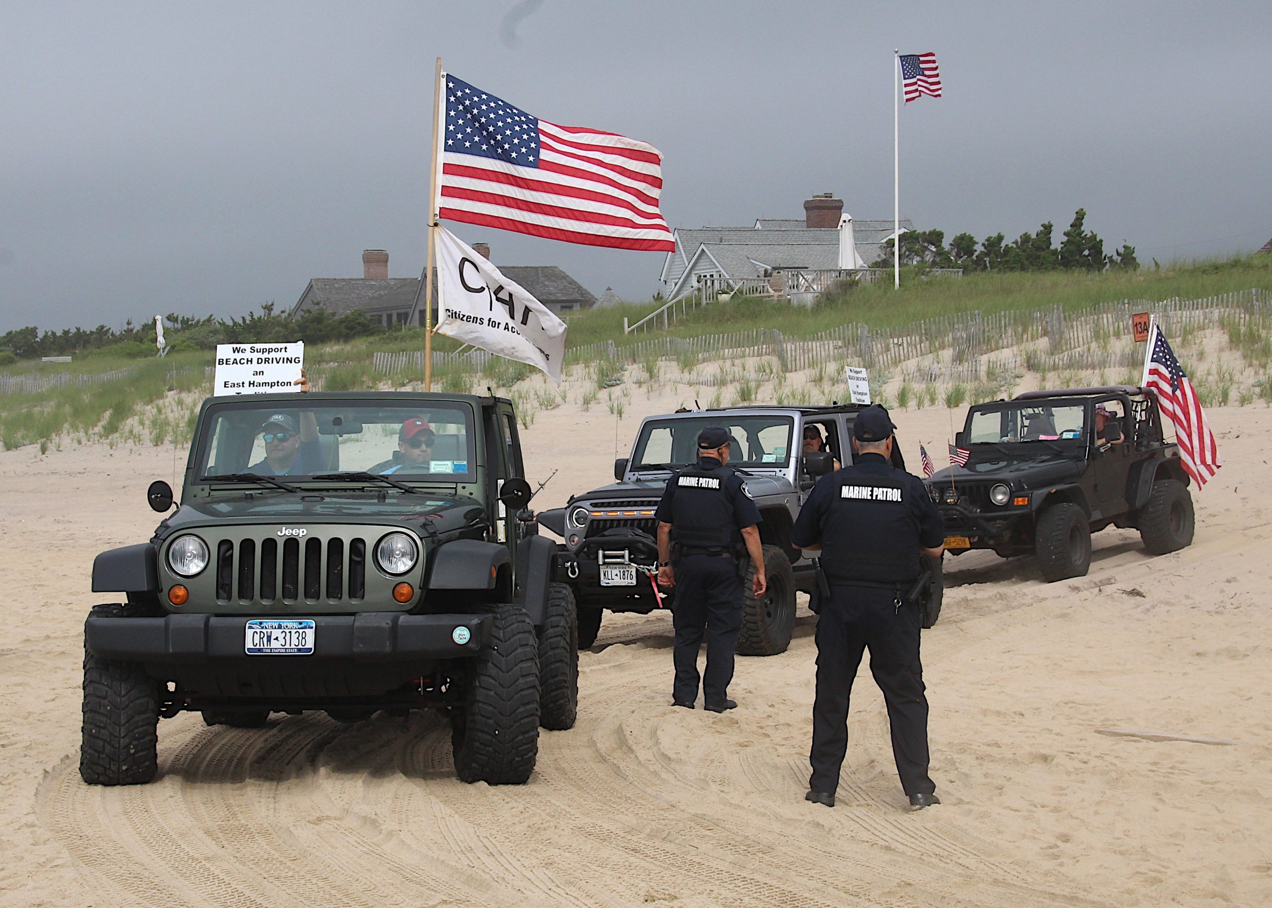 Dozens of trucks paraded onto the beach in Amagansett on Sunday morning in protest of a court ruling declaring the beach privately owned.