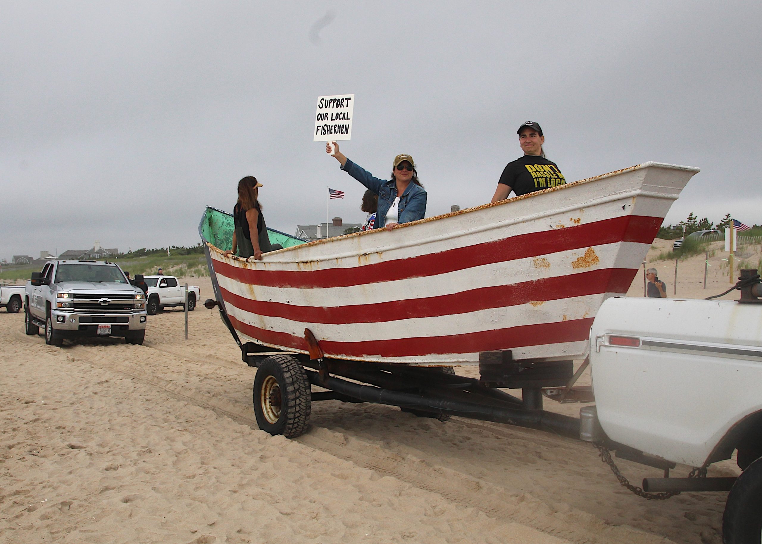 Dozens of trucks paraded onto the beach in Amagansett on Sunday morning in protest of a court ruling declaring the beach privately owned.