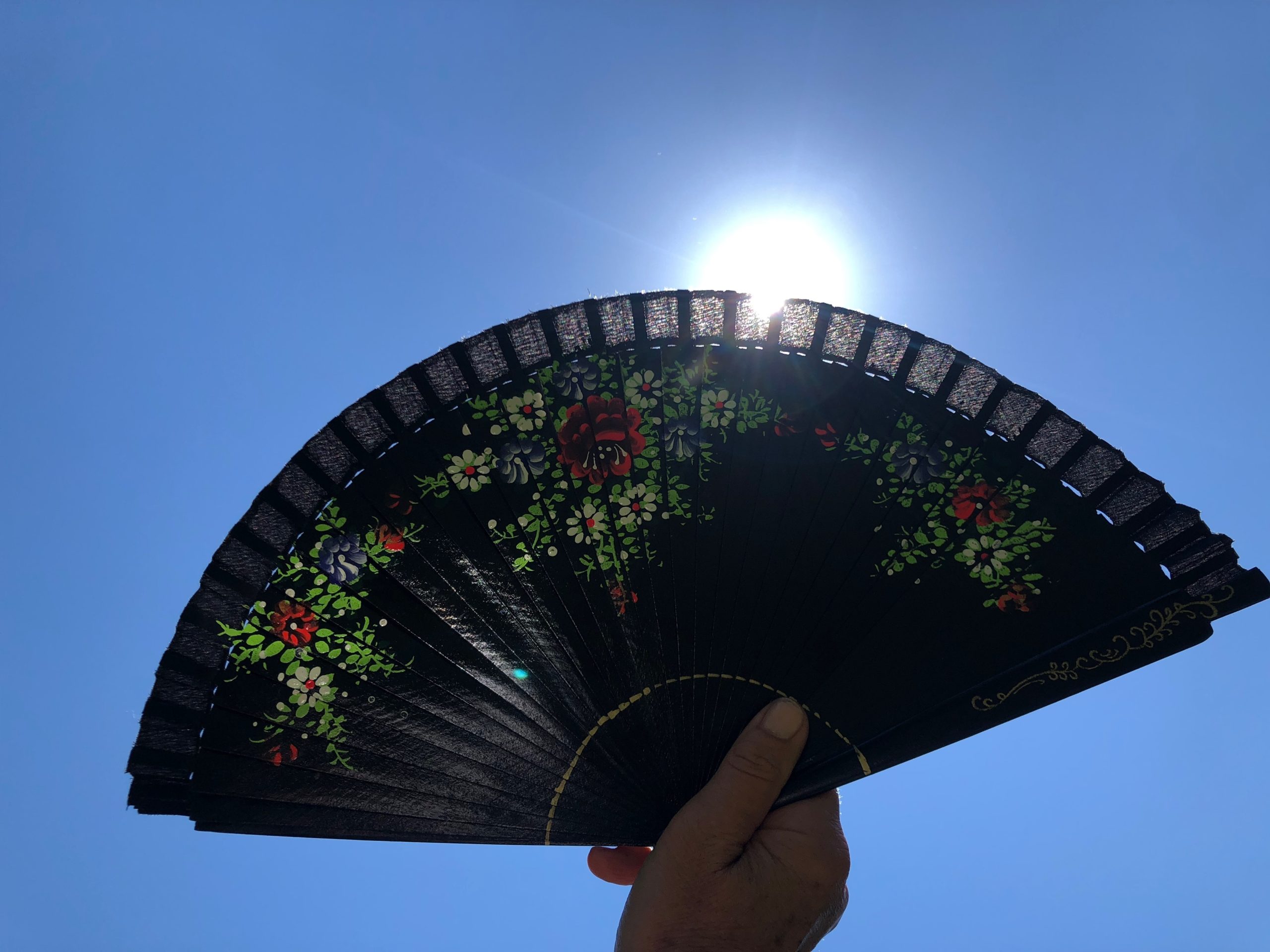 Hand fans are a secret weapon against the heat, providing instant relief and so easy to carry. A sturdy silk fan that flips open fast costs about $10.