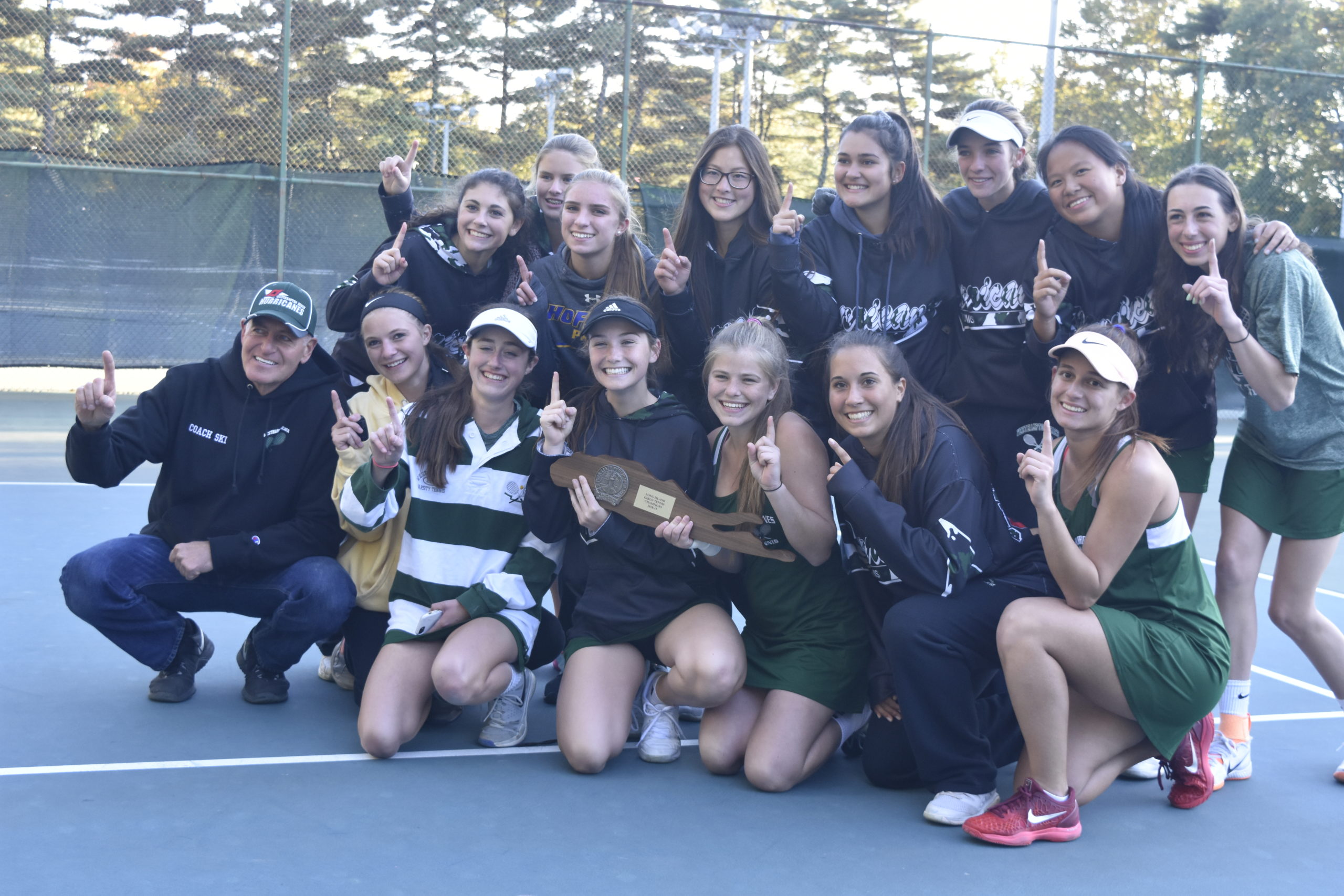 John Czartosieski, far left, led the Westhampton Beach girls tennis team to a Long Island Championship in 2018, the first team in Suffolk County to ever to do so.