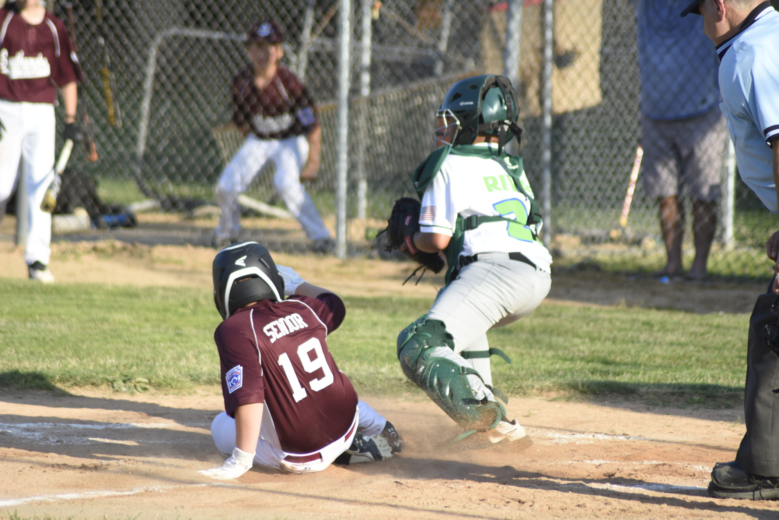 Cole Senior slides safely into home plate for a Southampton run.