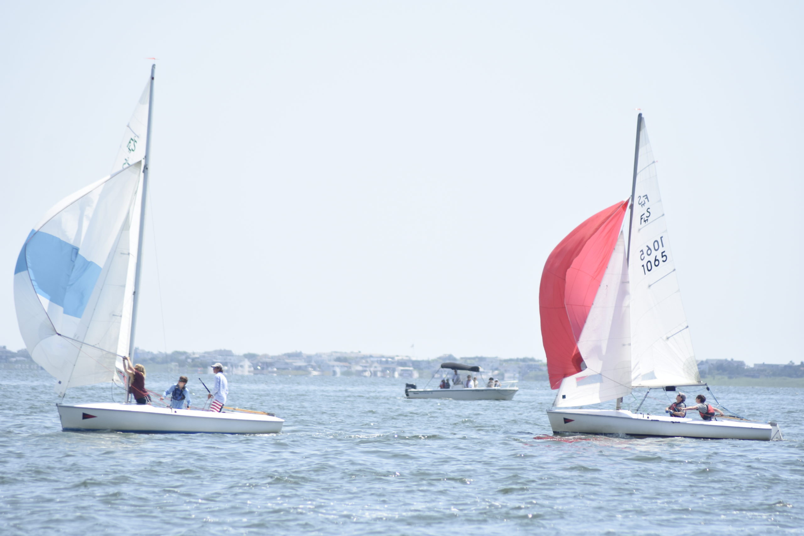 Alex Wilcenski, Laurel Wilcenski and Brady Schultz, left, and Danny Strebel and Michael Strebel are the first sailors to open up their spinnakers.