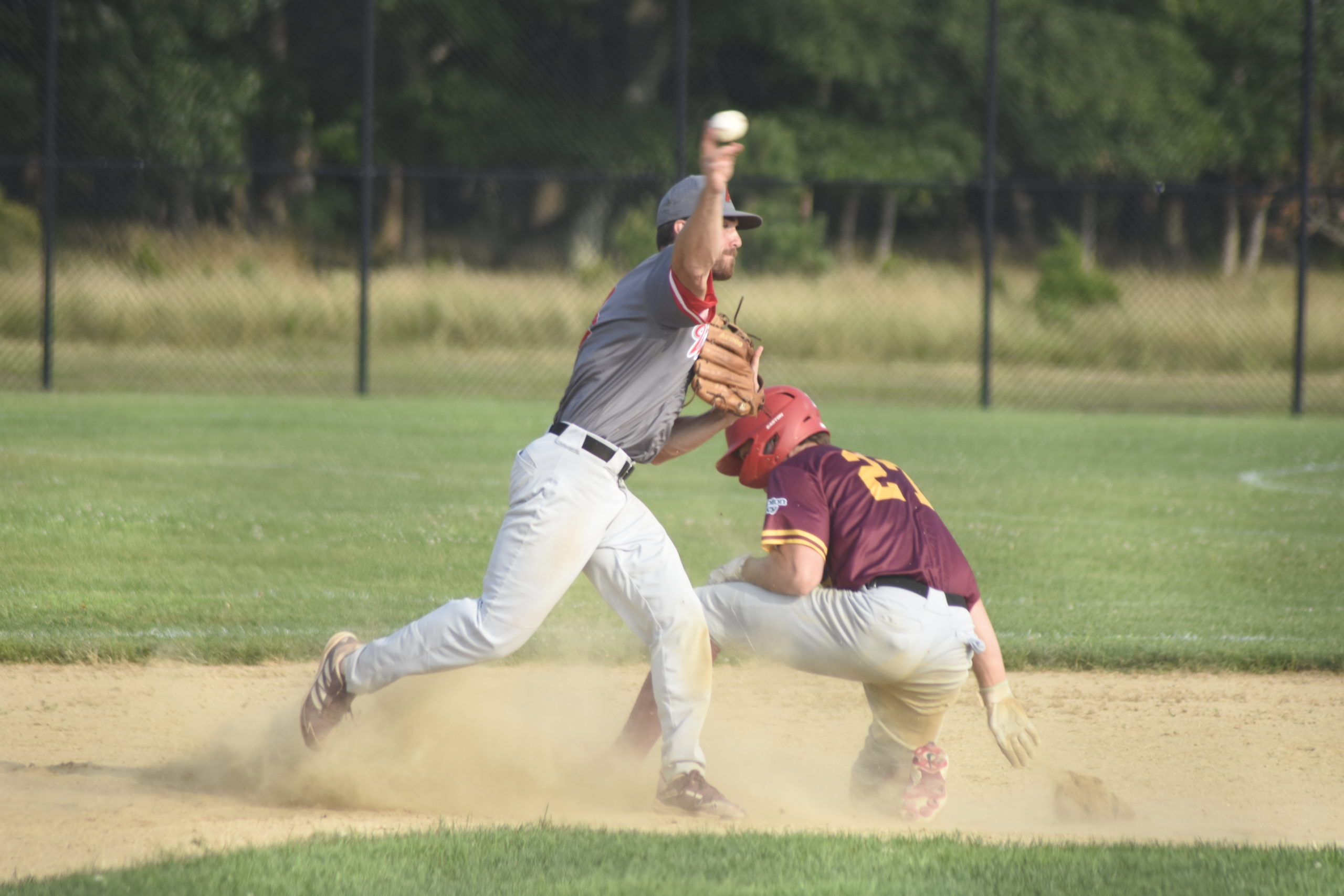 Westhampton second baseman Jake Liberatore (Iona) fires to first to try and get the back end of a double play.