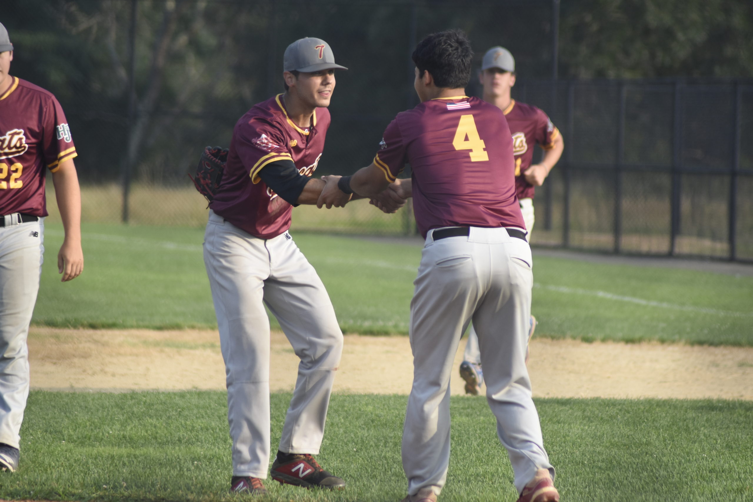 Pitcher Coleton Reitan (Wesleyan) is congratulated by teammate Tyler Galletti (Sacred Heart) after helping the Tomcats defeat the Westhampton Aviators, 1-0, on Sunday to reach the HCBL Championship.