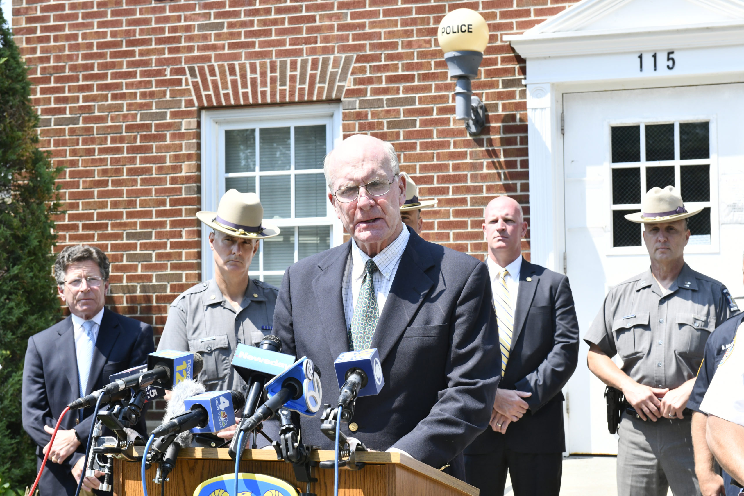 Quogue Mayor Peter Sartorius addresses the crowd at a press conference at the village police station on Tuesday morning.  DANA SHAW